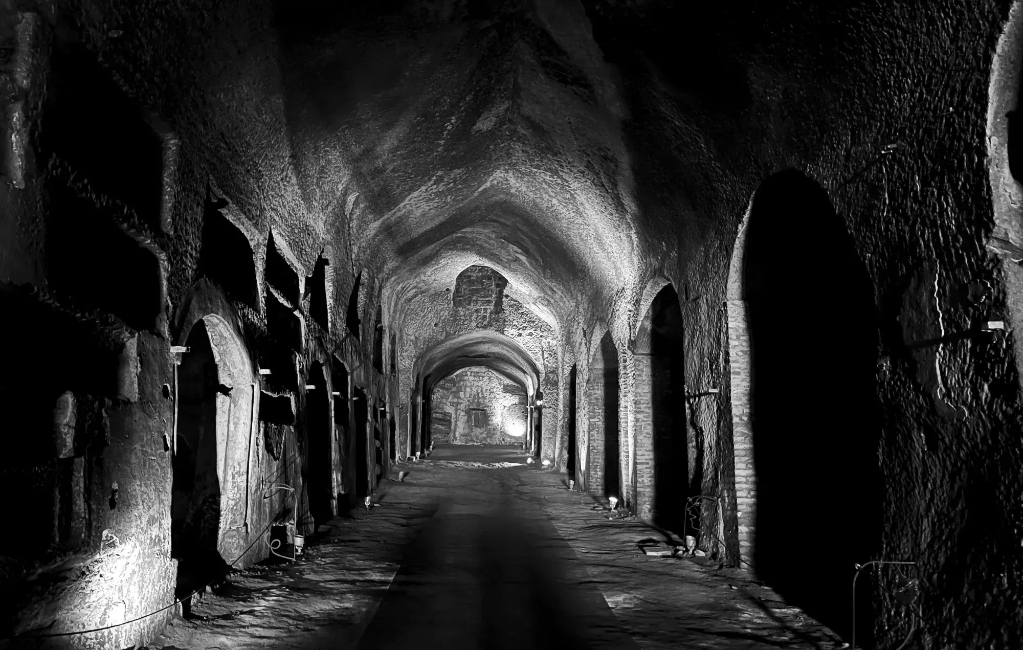 Black and white of the main tunnel in Catacombe di San Gennaro.