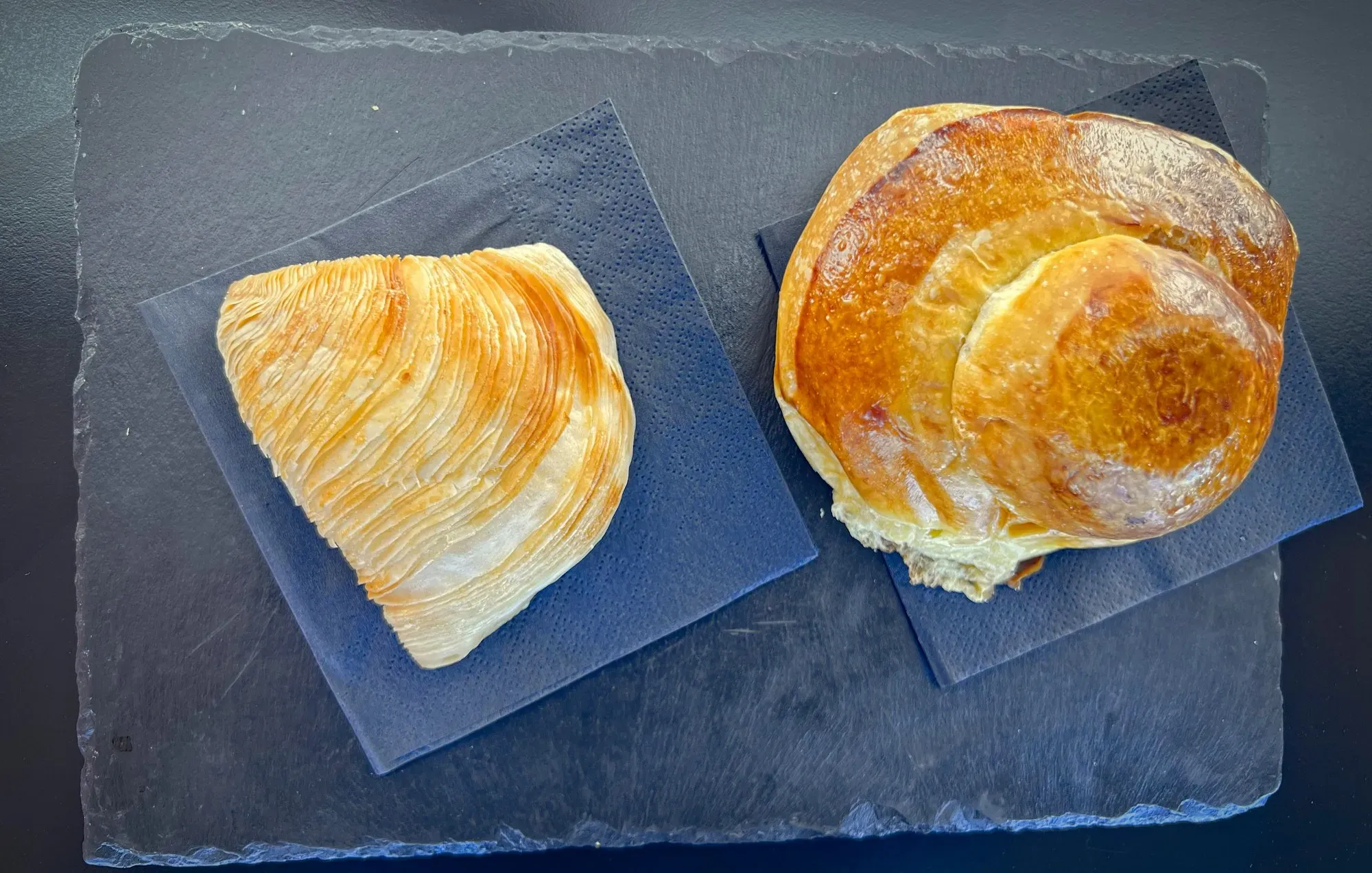 Two types of Sfogliatella. An overhead shot of Sfogliatella Riccia on the left, and Sfogliatella Frolla on the right.