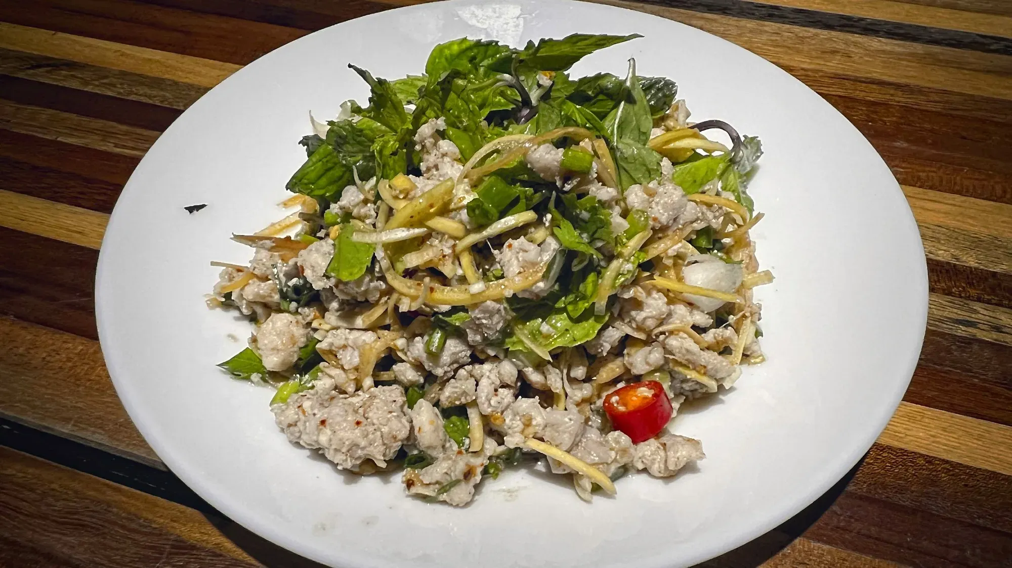 Laap dish at a restaurant, overhead angle shot.