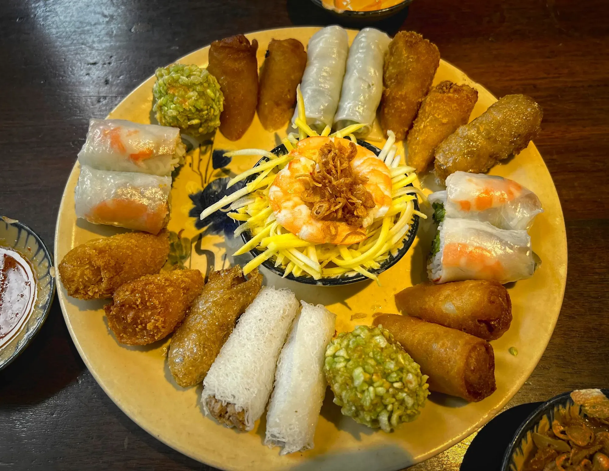 A platter of different Vietnamese spring rolls, overhead shot.