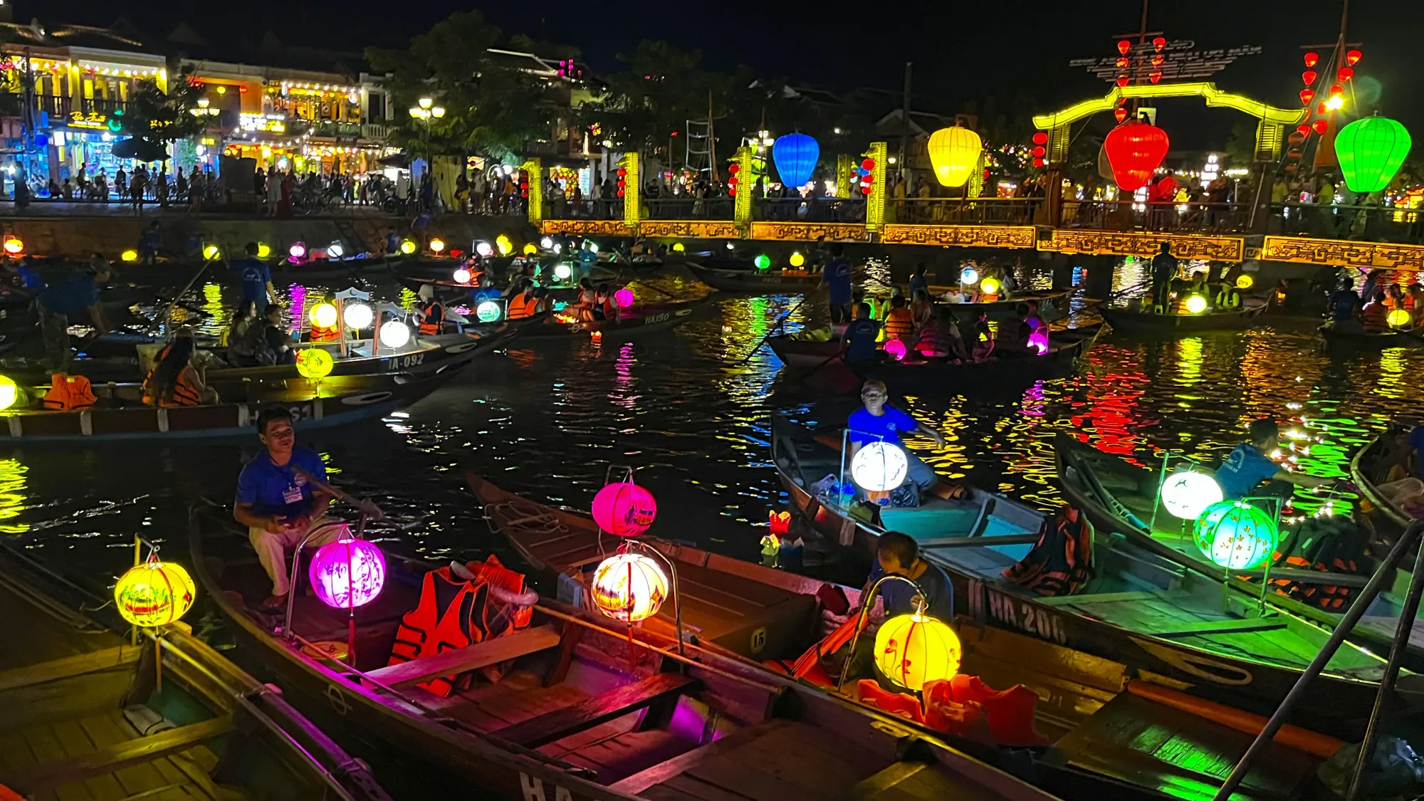 River and Bridge in Hoi An, Vietnam covered with colored lanterns and boats