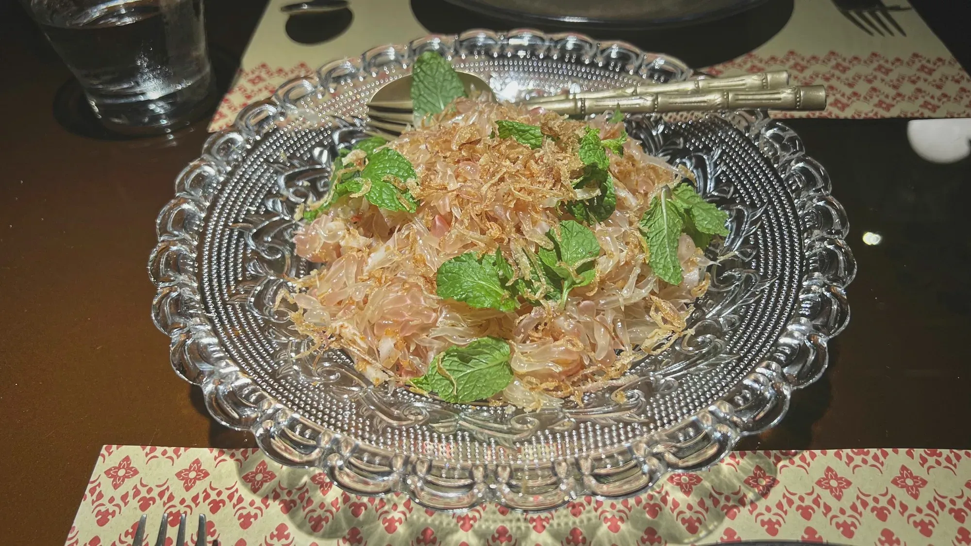 Pomelo salad served on a glass plate.