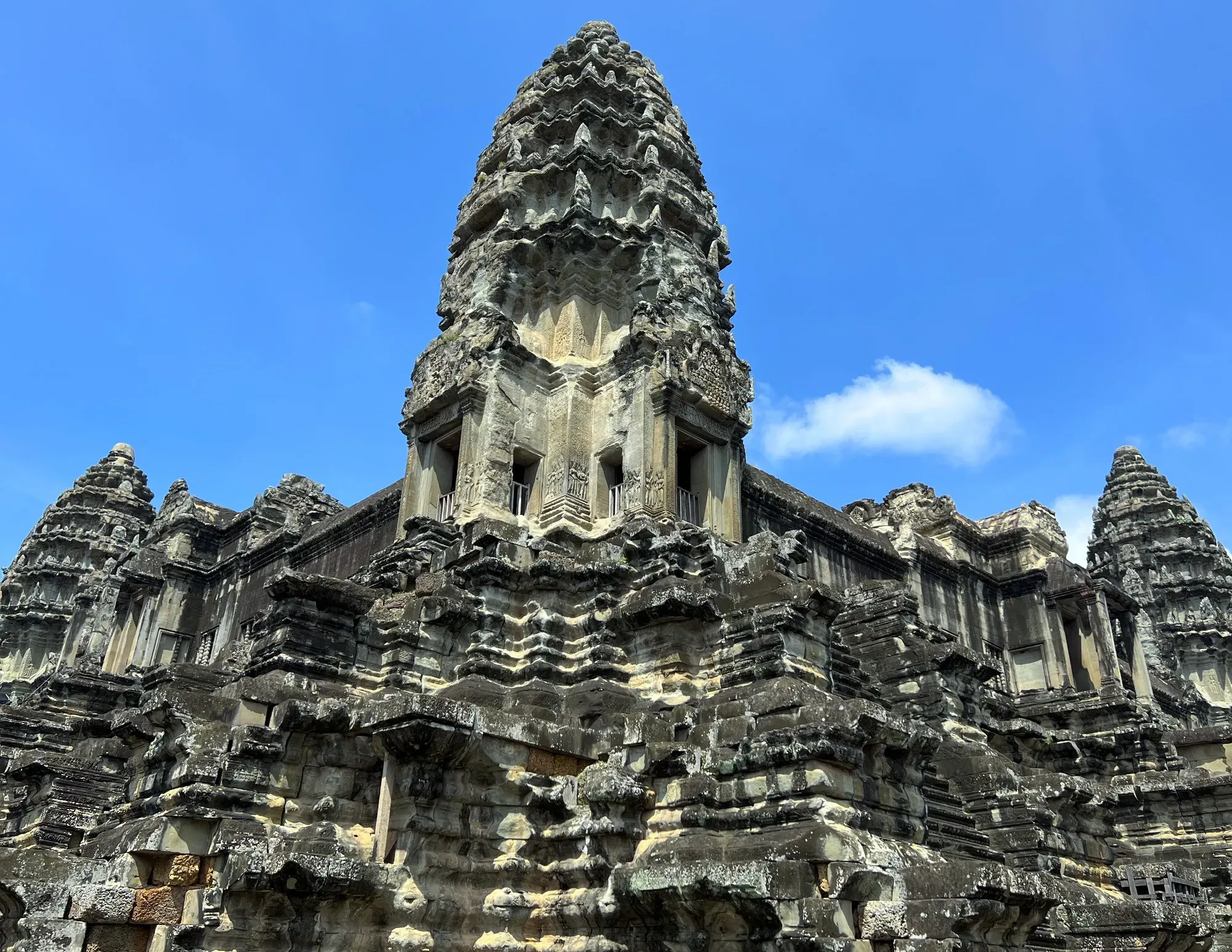 Photo angled up of one of the Angkor Wat towers
