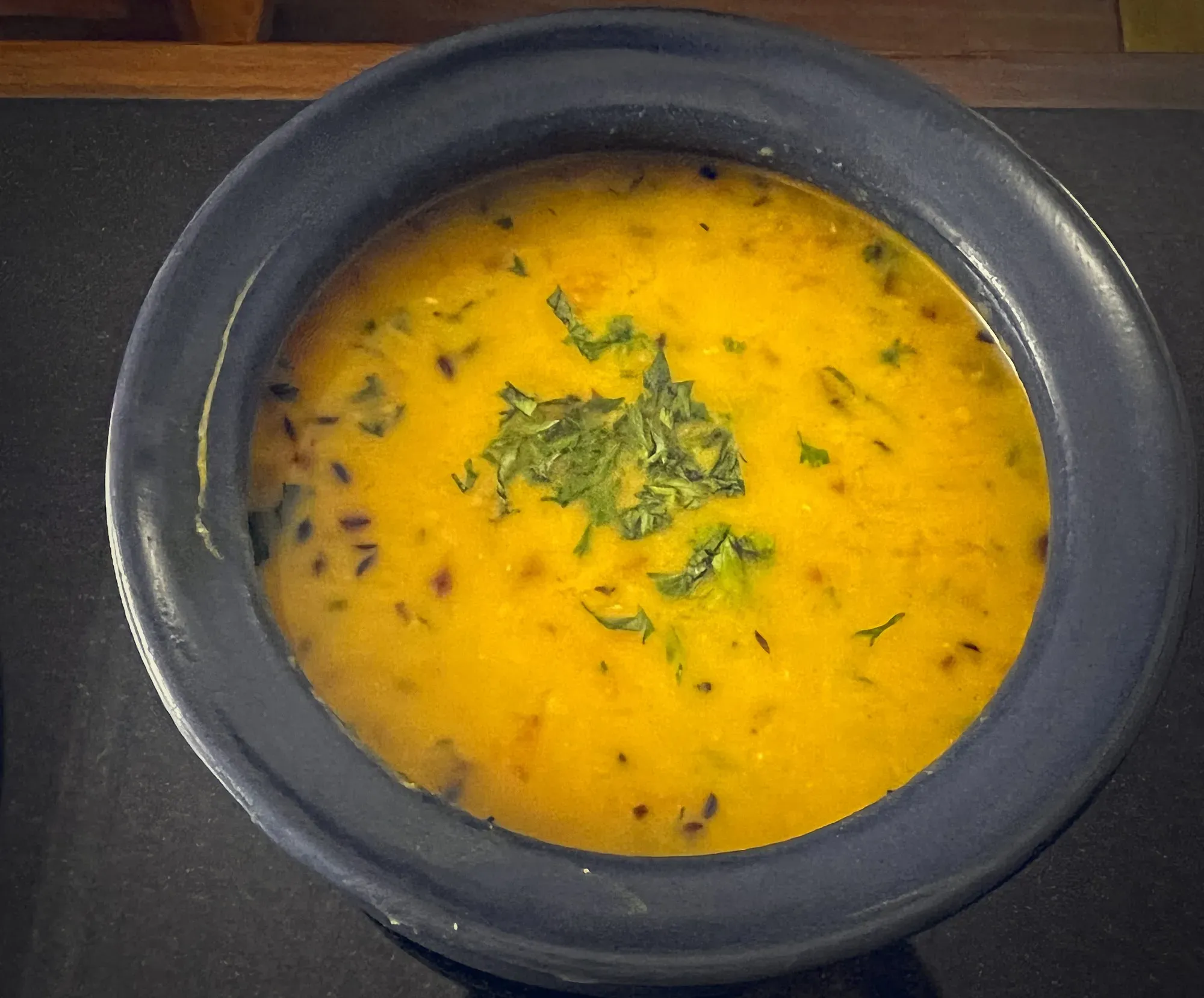 Close up overhead shot of Dal Tadka in a blue ceramic bowl.