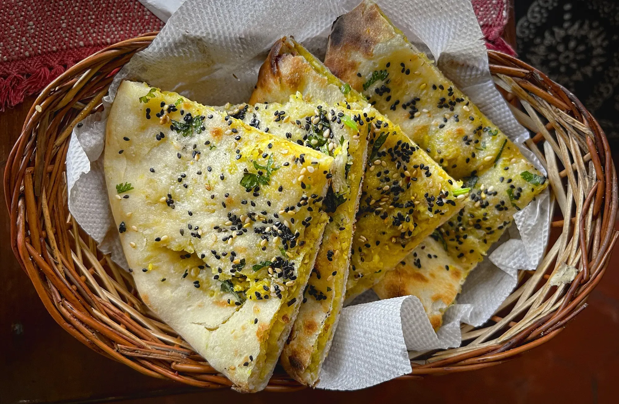 Basket of stuffed kulcha, overhead shot.