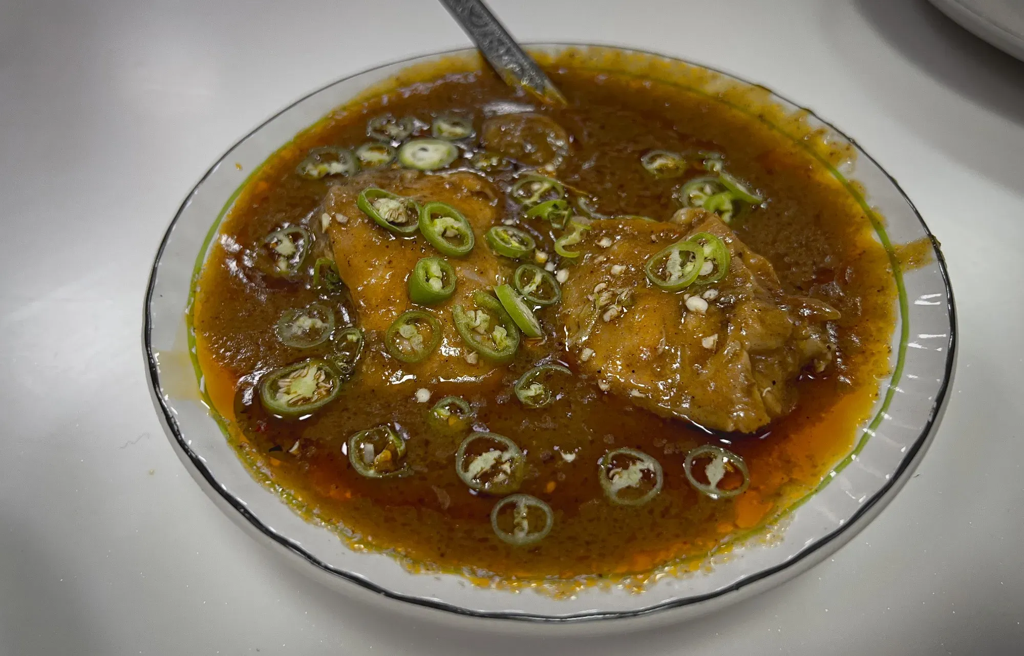 Angled shot of a bowl of Nihari.