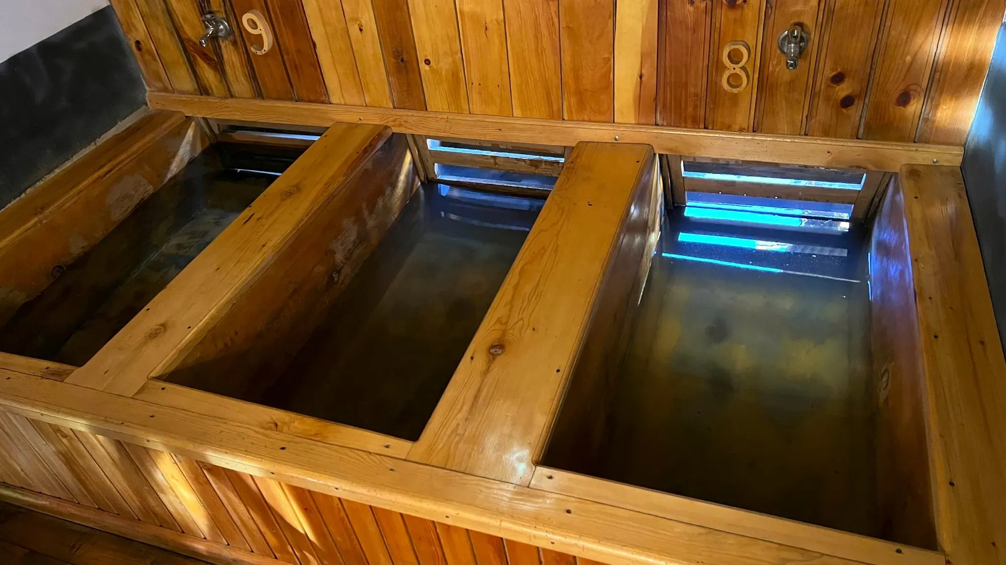 Three wooden bathtubs