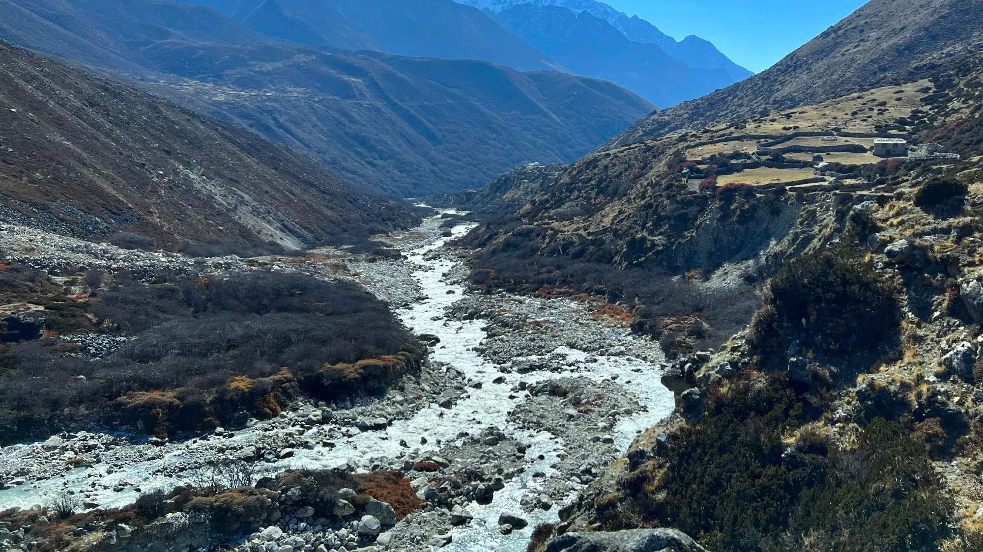 River running through the valley turned icy above the treeline