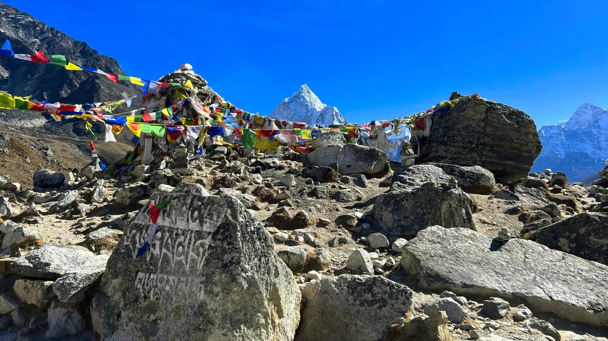 Carved rocks with prayer flags strung between them
