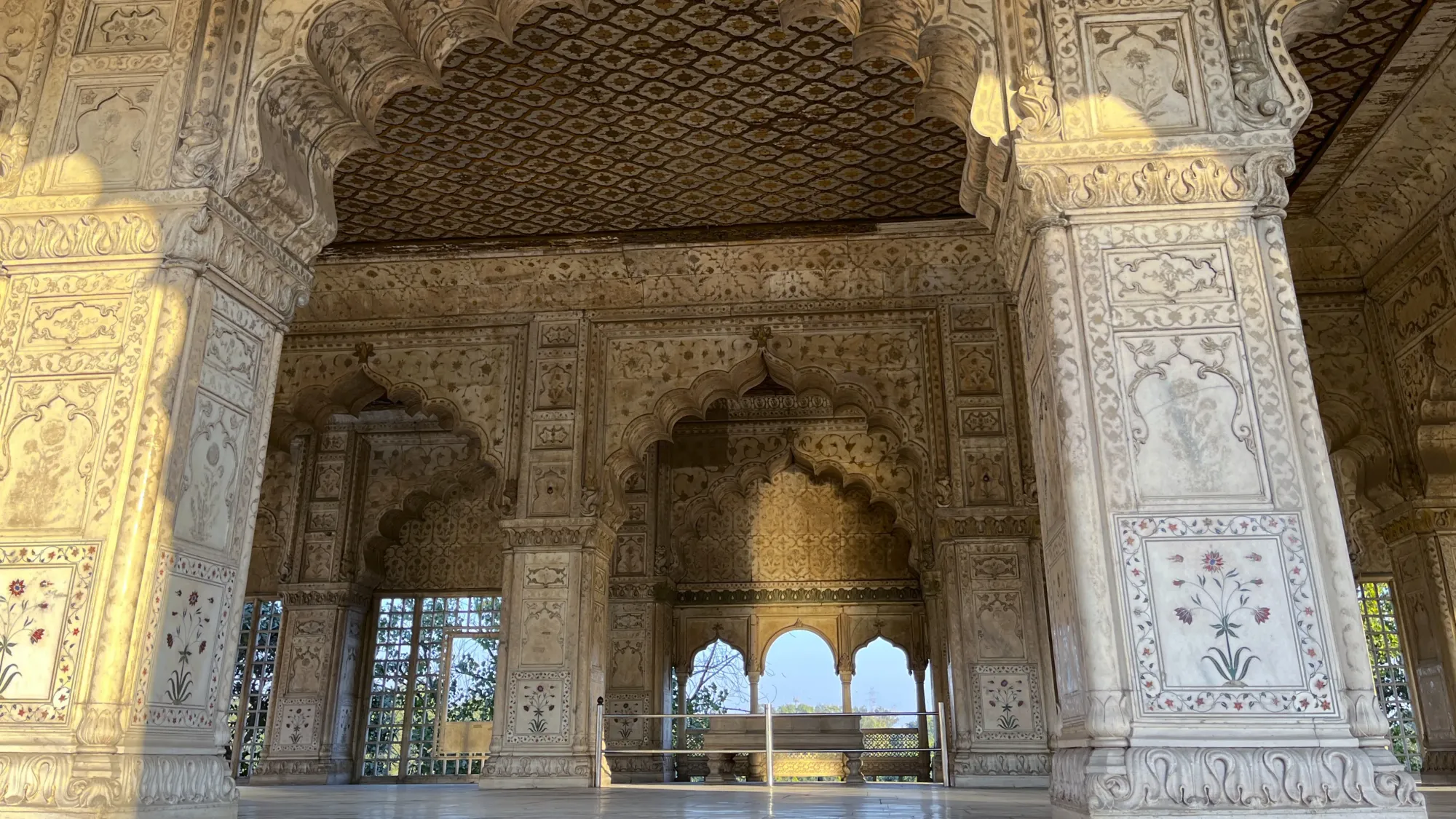 Scalloped arch ways of white marble with inlaid semiprecious stones in floral patterns