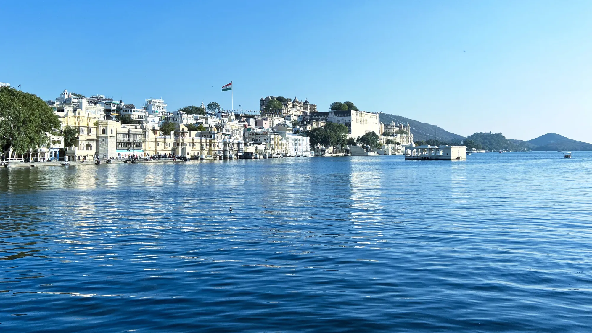 White city of Udaipur looked at across the blue of Lake Pichola