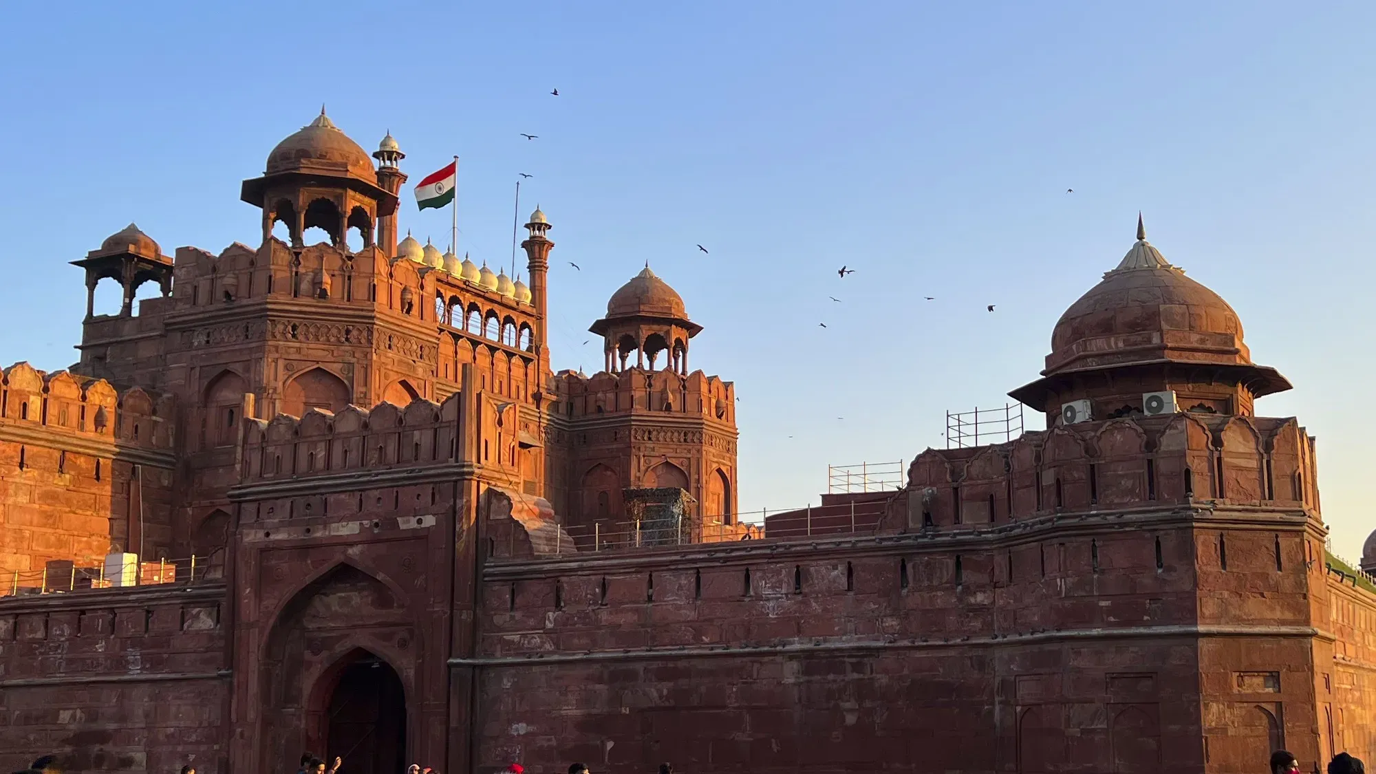 The Red Fort in Delhi with birds flying over it