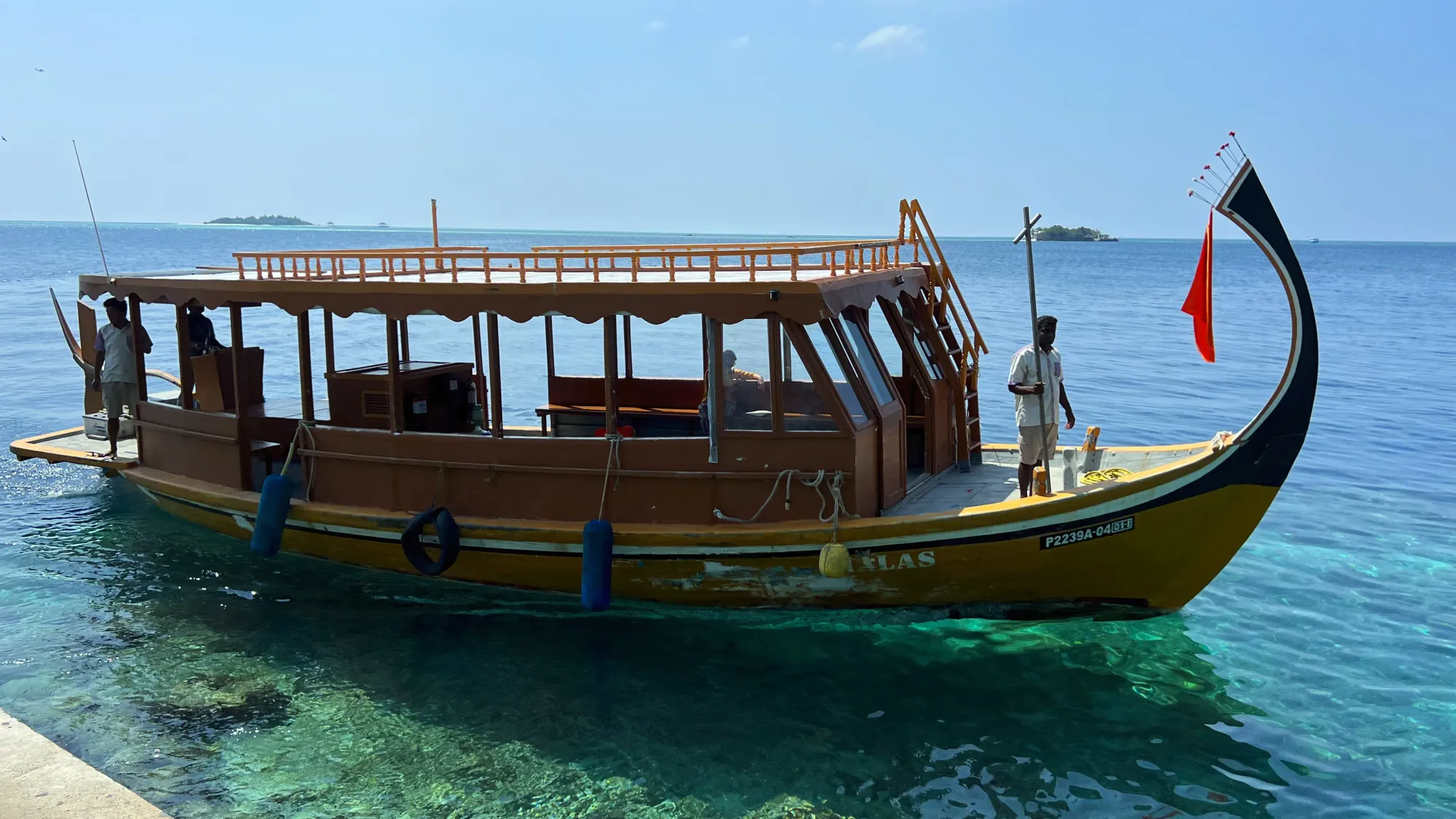 Boat with a curved hull and two men aboard