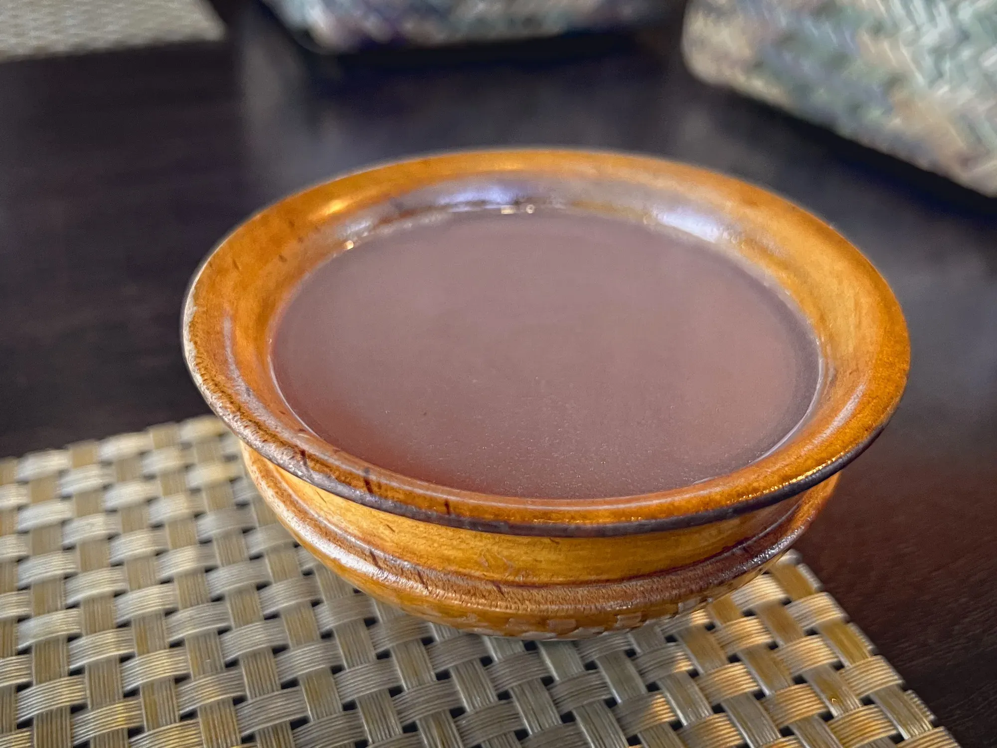 Suja in a small wooden cup-bowl, angled shot.