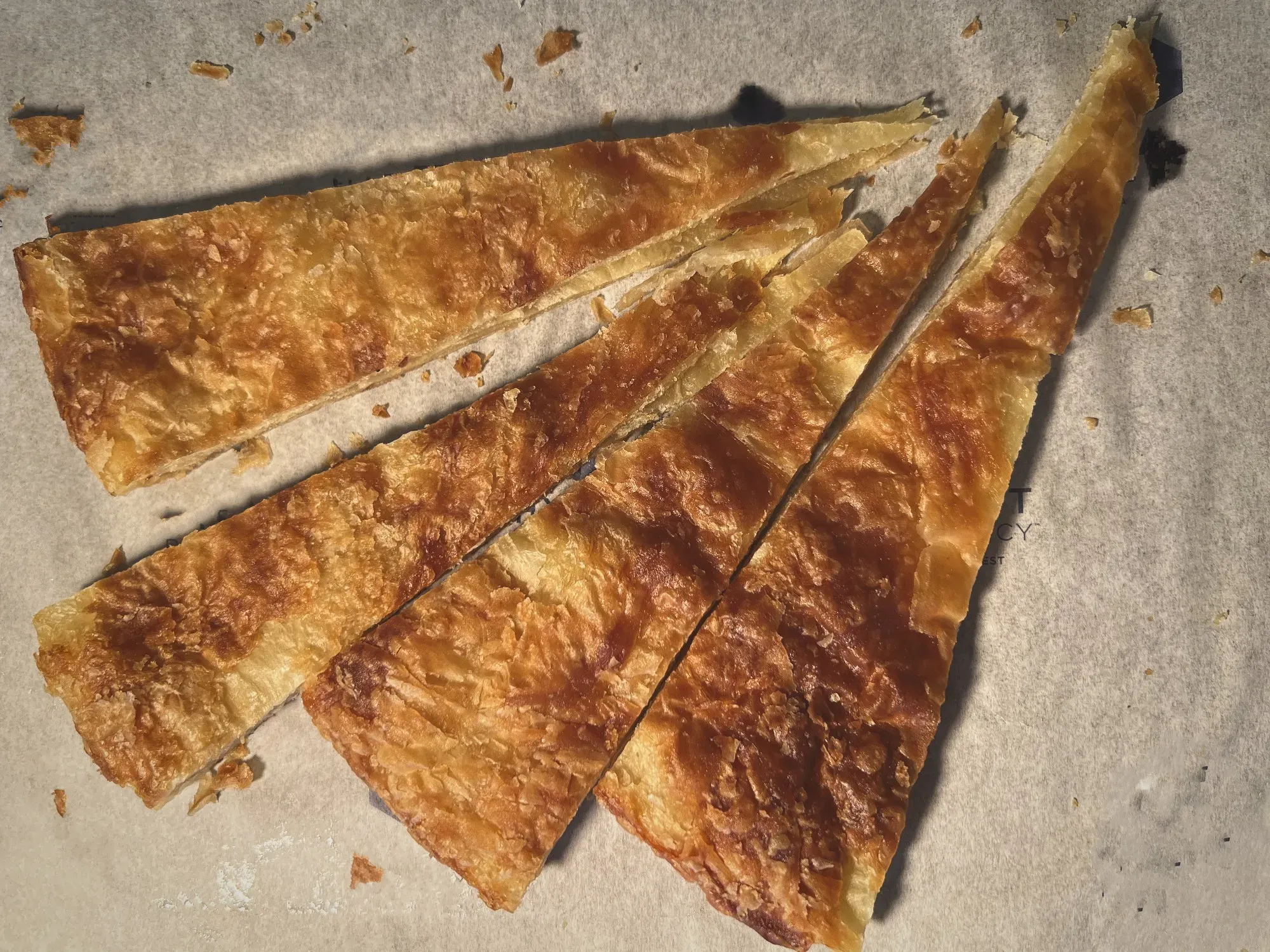 Four thin slices of Feteer Meshaltet, overhead shot.