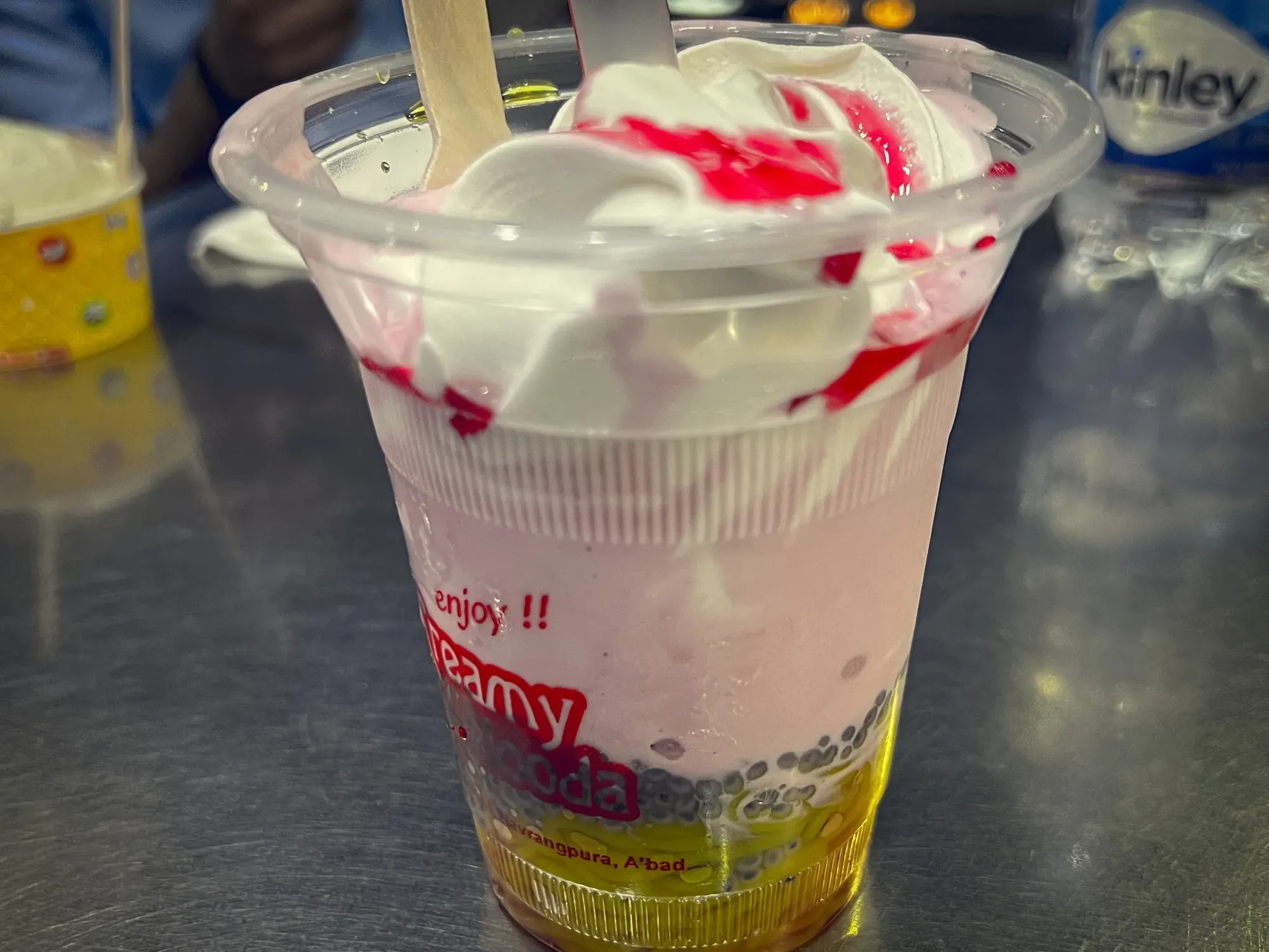 Close up side shot of a cup of Falooda, showing the various layers when served.