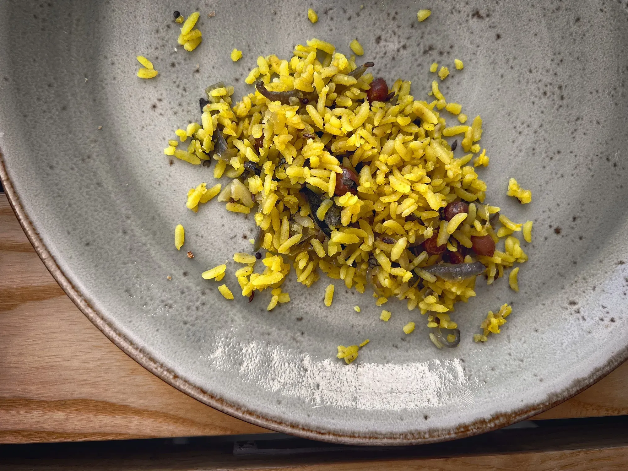 Close up, overhead shot of a partial plate of Poha.