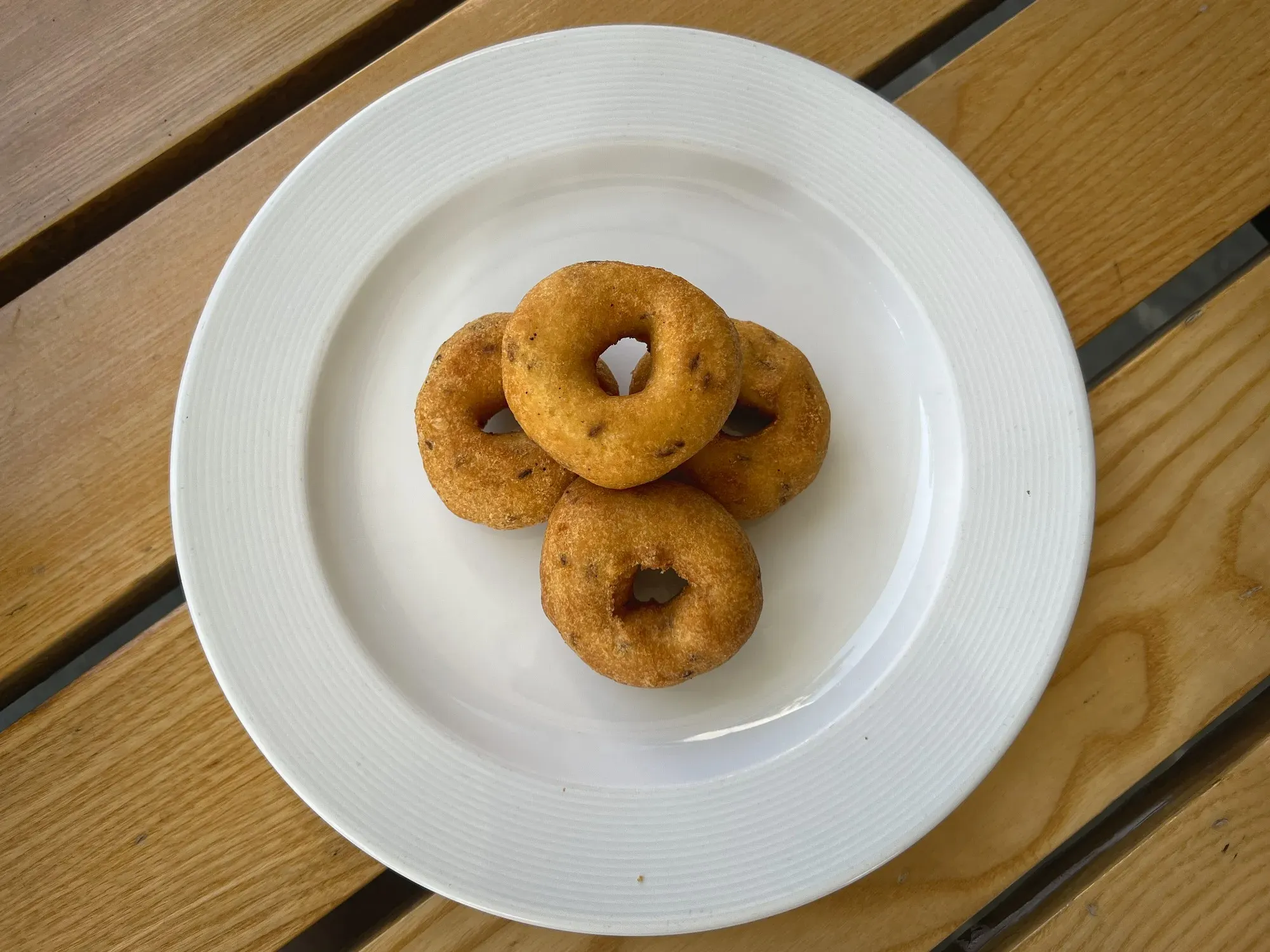 Overshot of a plate with four Medu vada.