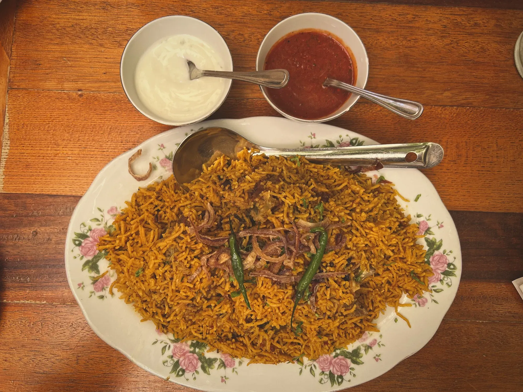 A serving plate of Machbous with side sauces.