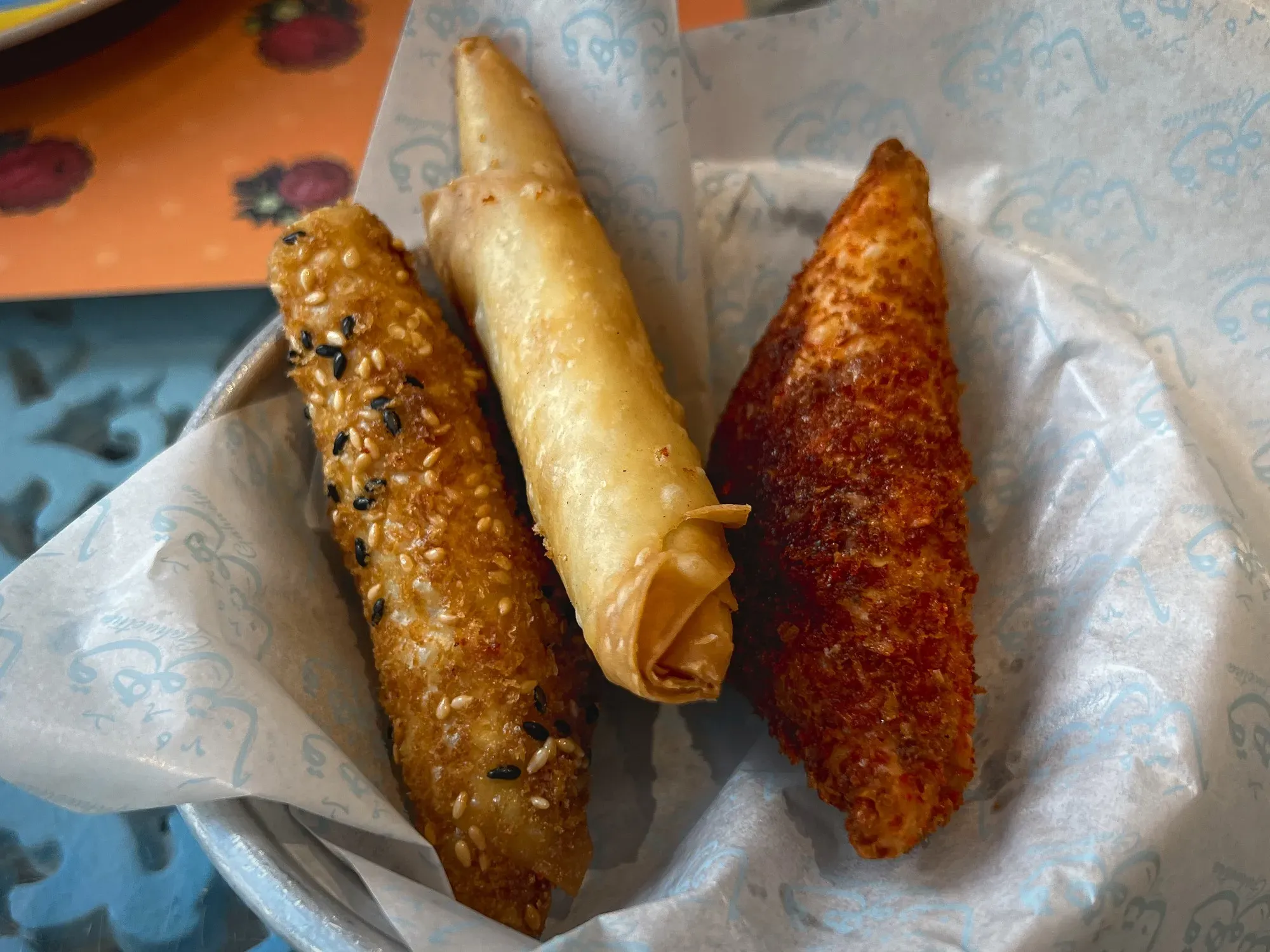 Tray with three different styled Samboosa, angled shot.