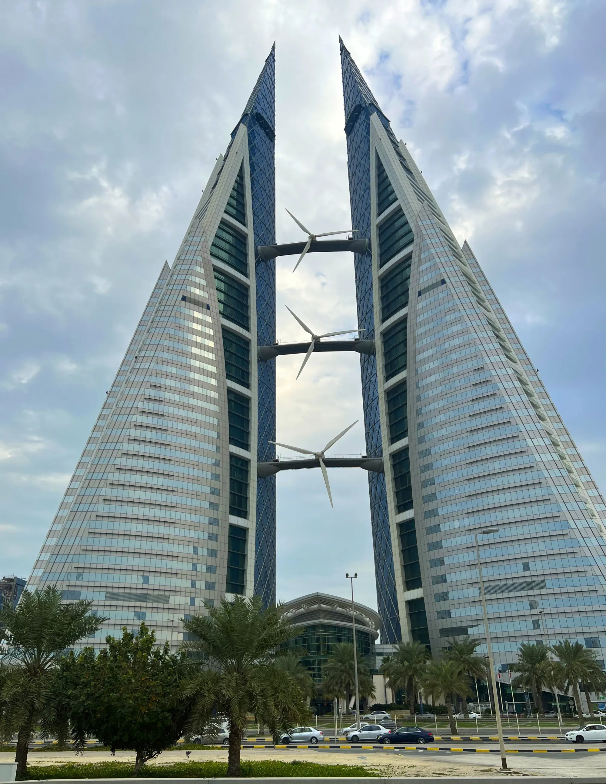 Glass skyscraper designed in two triangular halves with bridges running between them