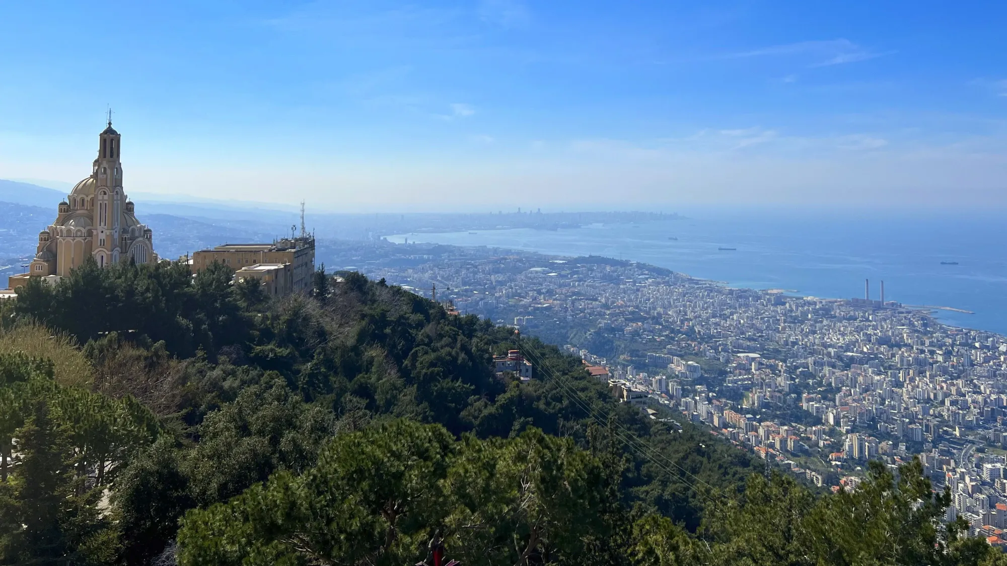 Close-up of a church on a hill looking down over the coastal cities of Lebanon