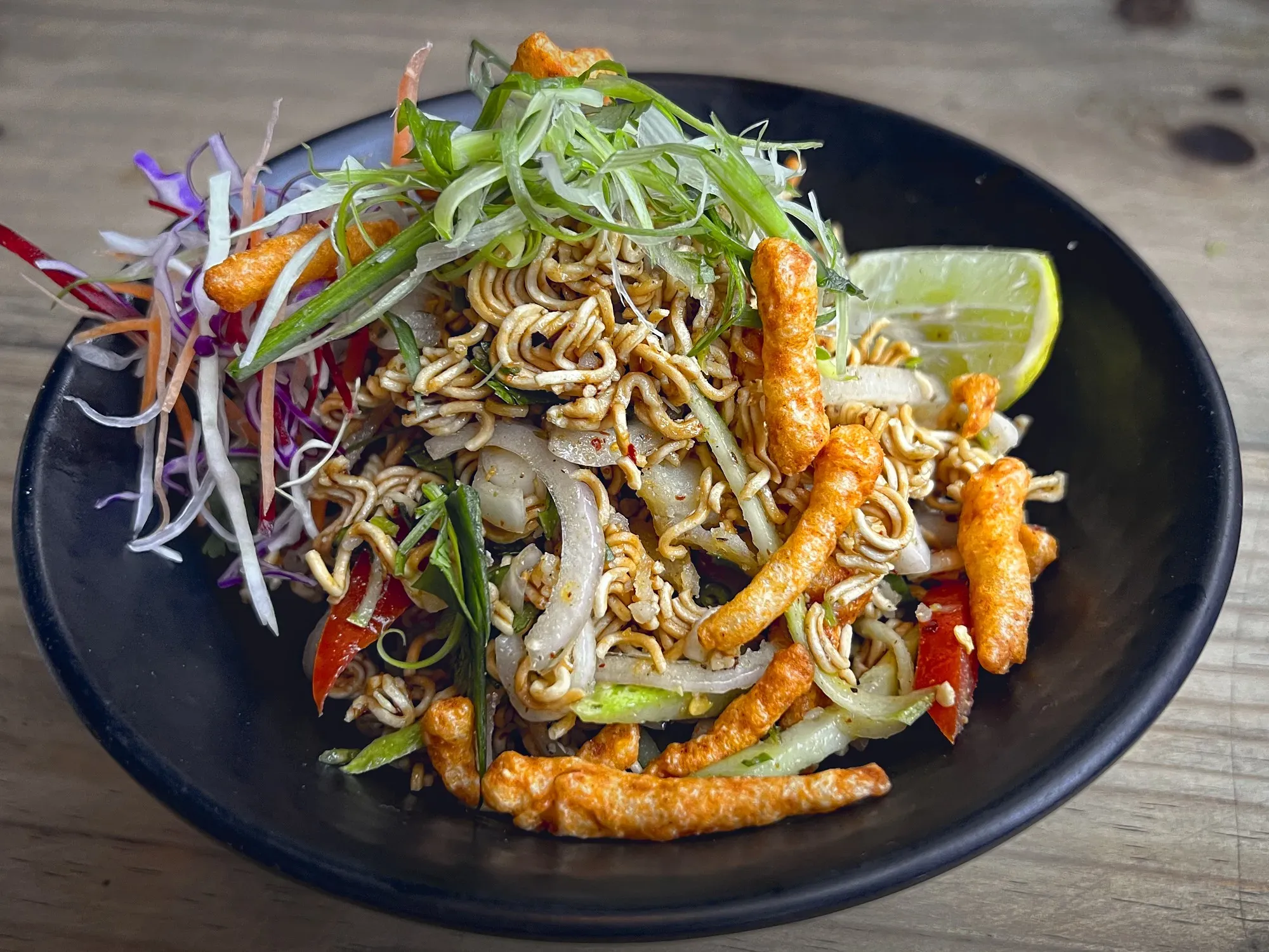 Angled shot of Kurkure Waiwai Sadheko in a bowl.