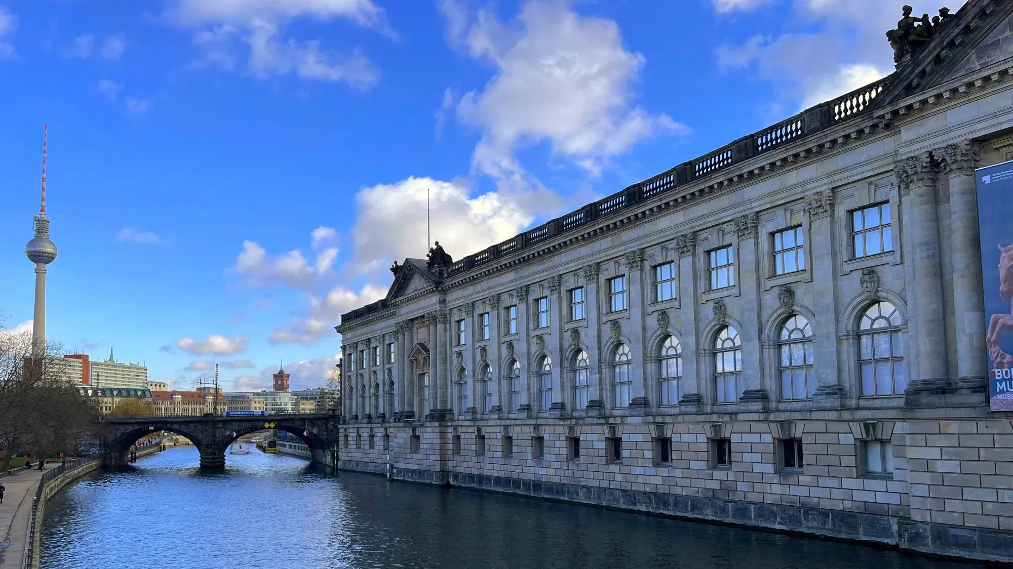 Stone museum overlooking the river with a bridge running between