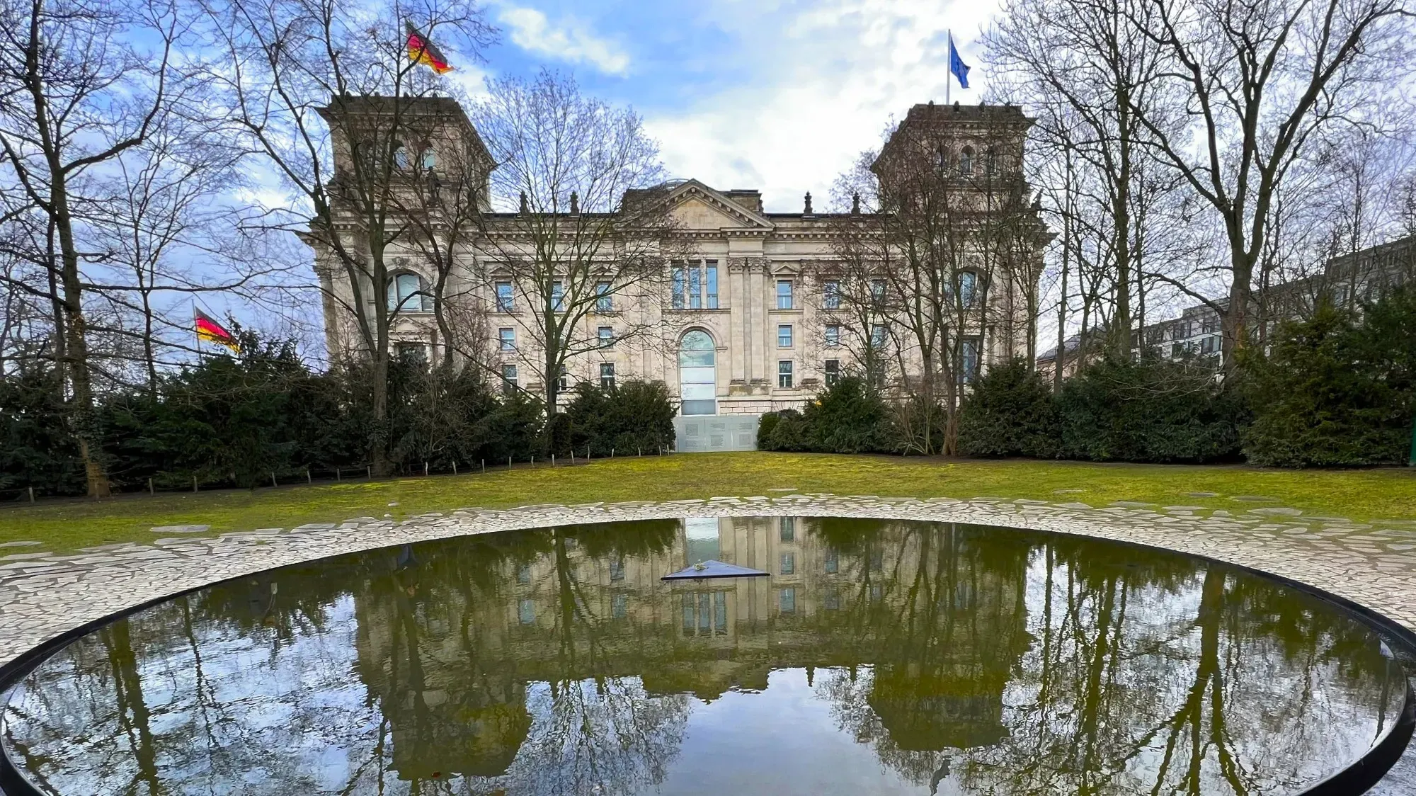 Memorial pool with the parliament building reflected in it