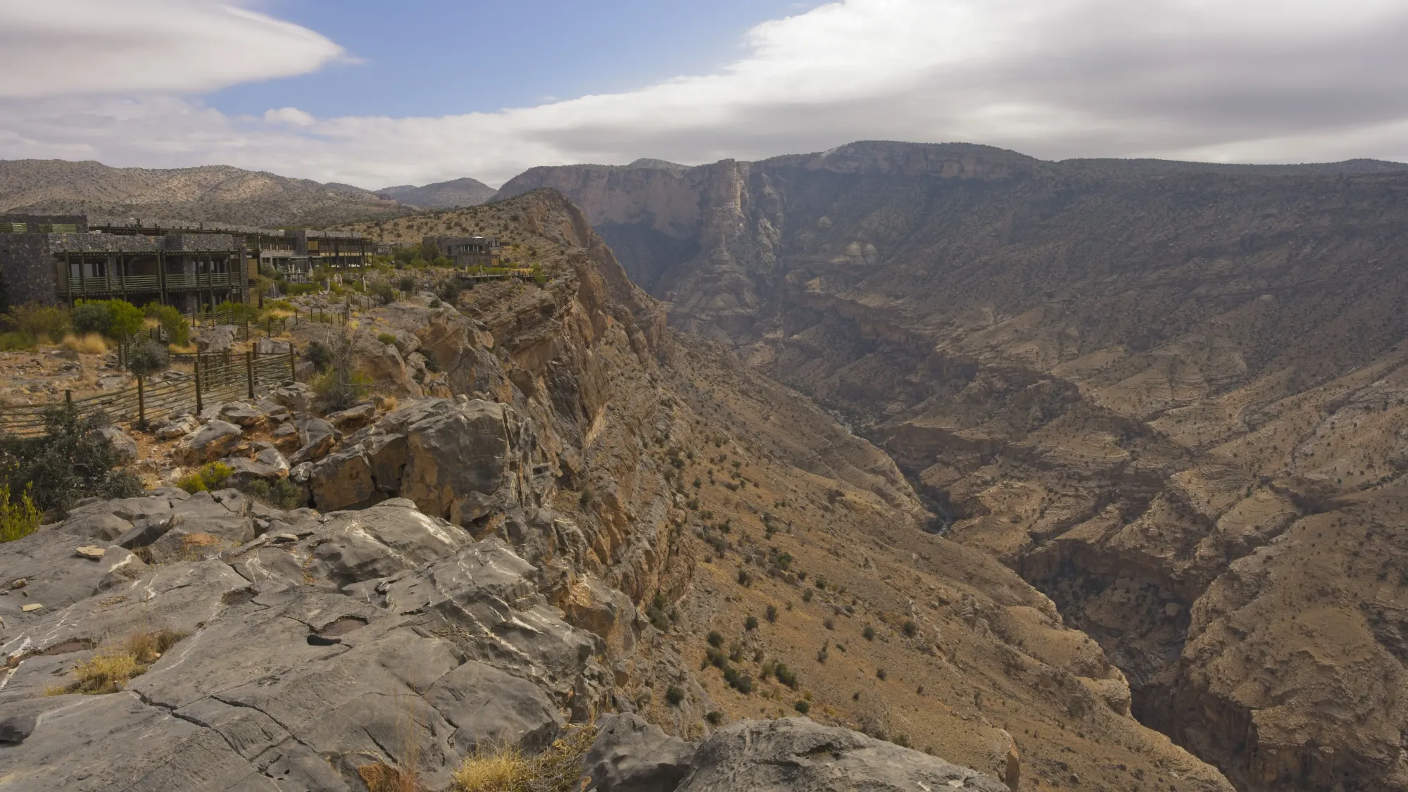 Multicolored rock valley with the resort perched on the cliff's edge