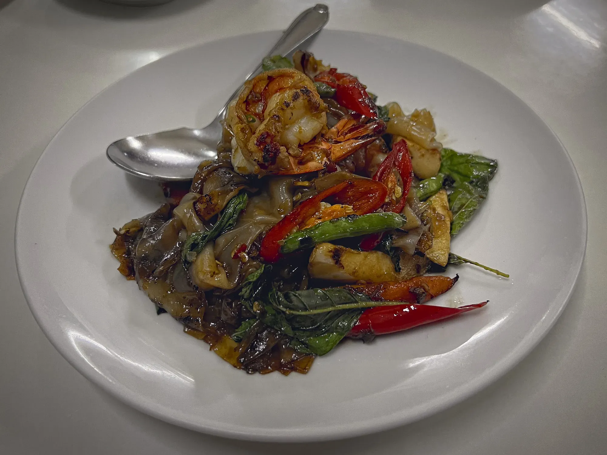 Angled shot of Drunken Noodles on a plate.