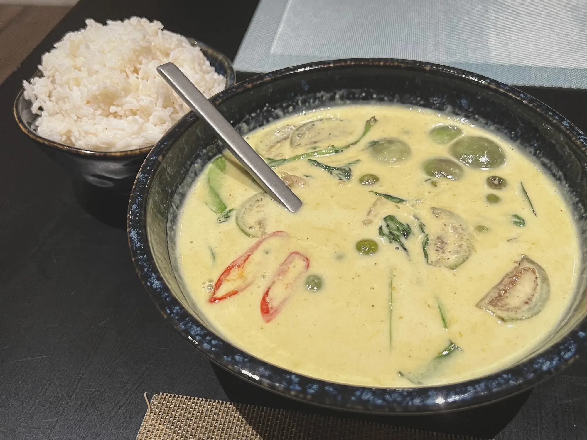 Green Curry with rice in the background.