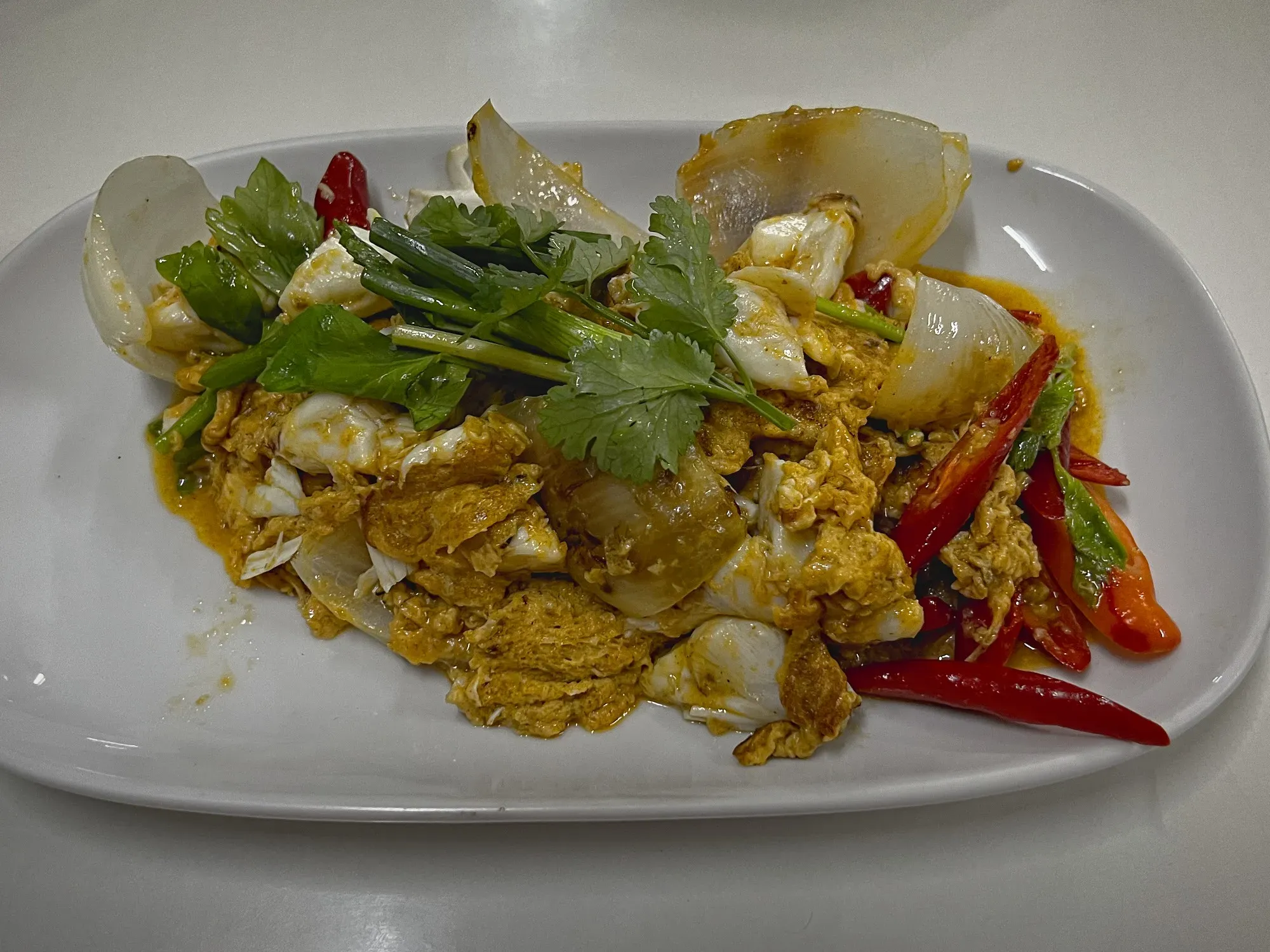 Poo Phad Phong Karee on a serving platter, angled shot.