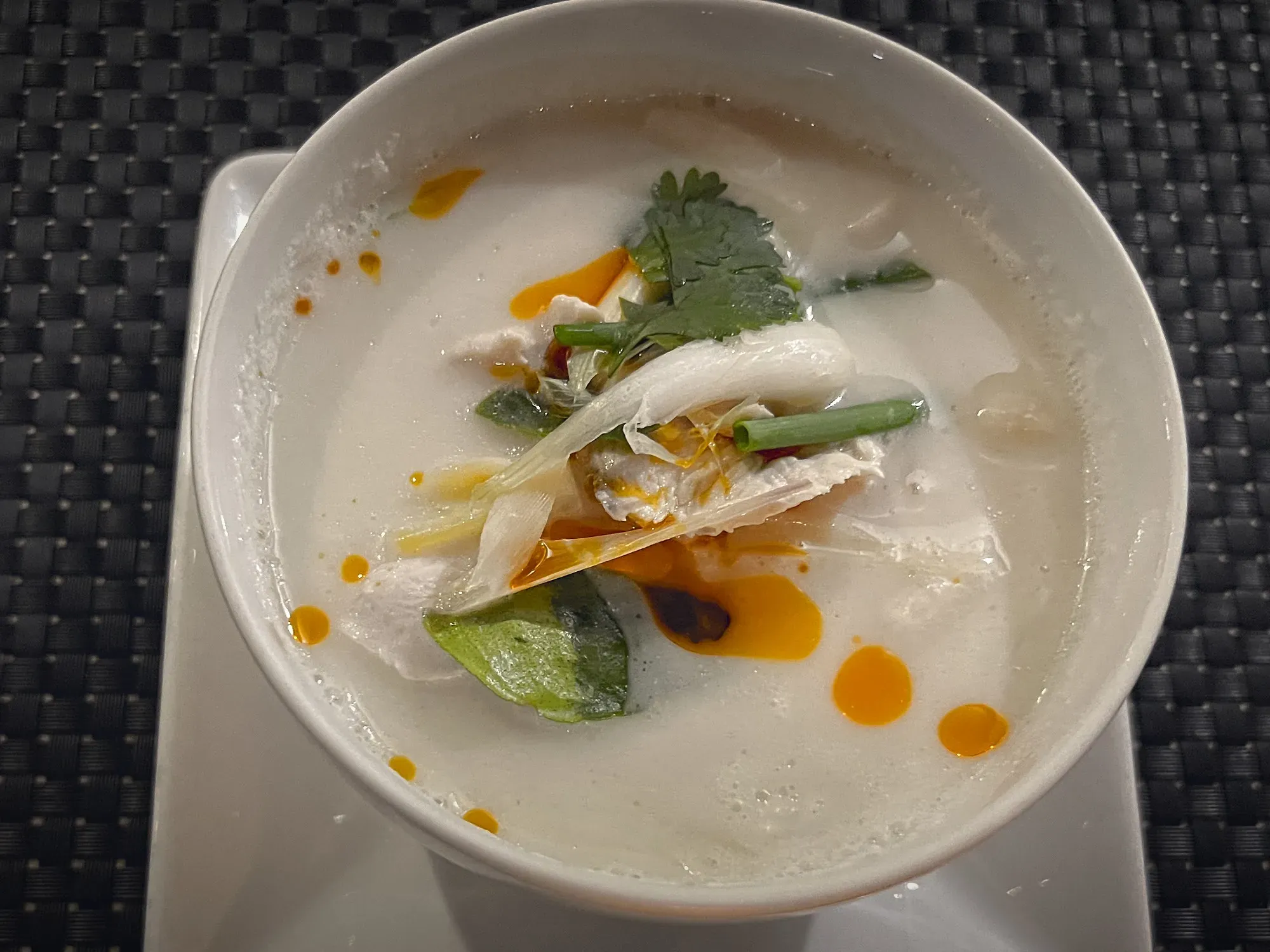 Tom Kha Gai in a bowl, overhead shot.