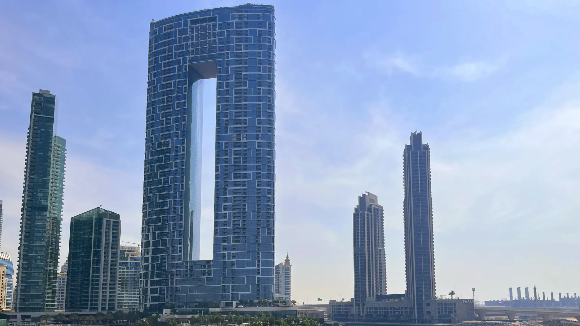 Glass skyscrapers including one with a whole in the middle