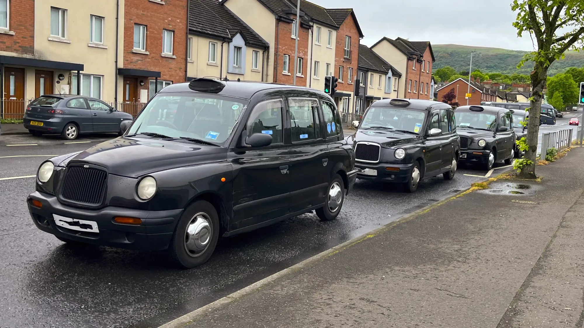 A row of Belfast's black taxis