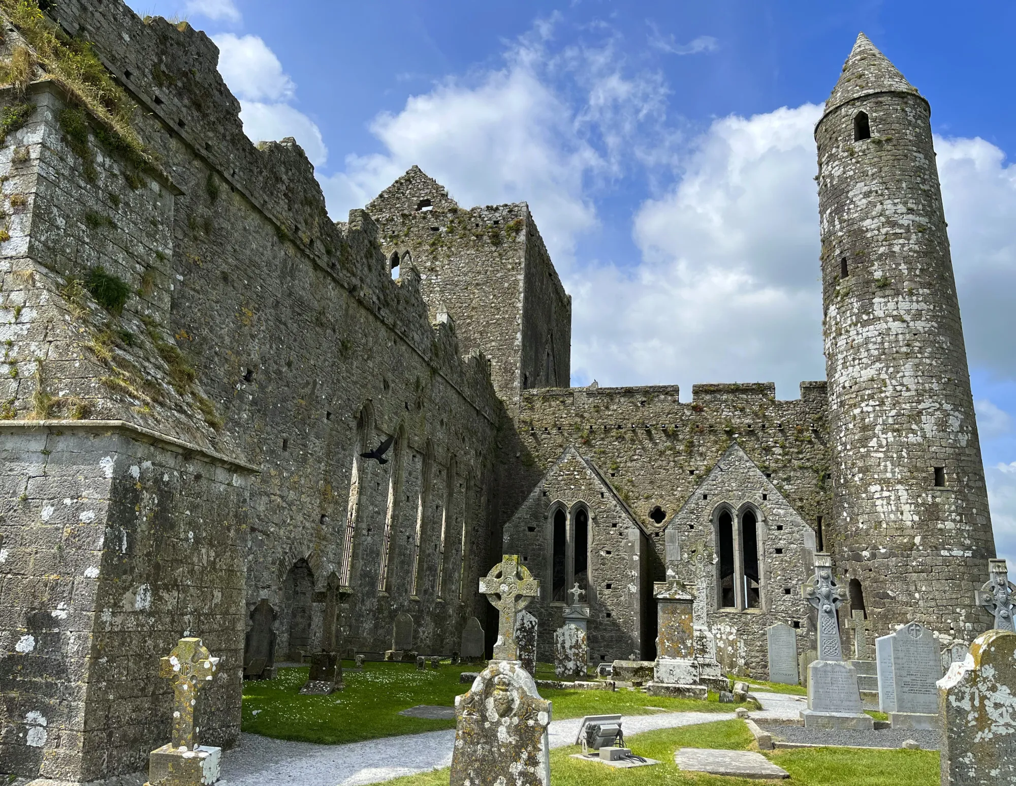 Grey stone towers with aged gravestones