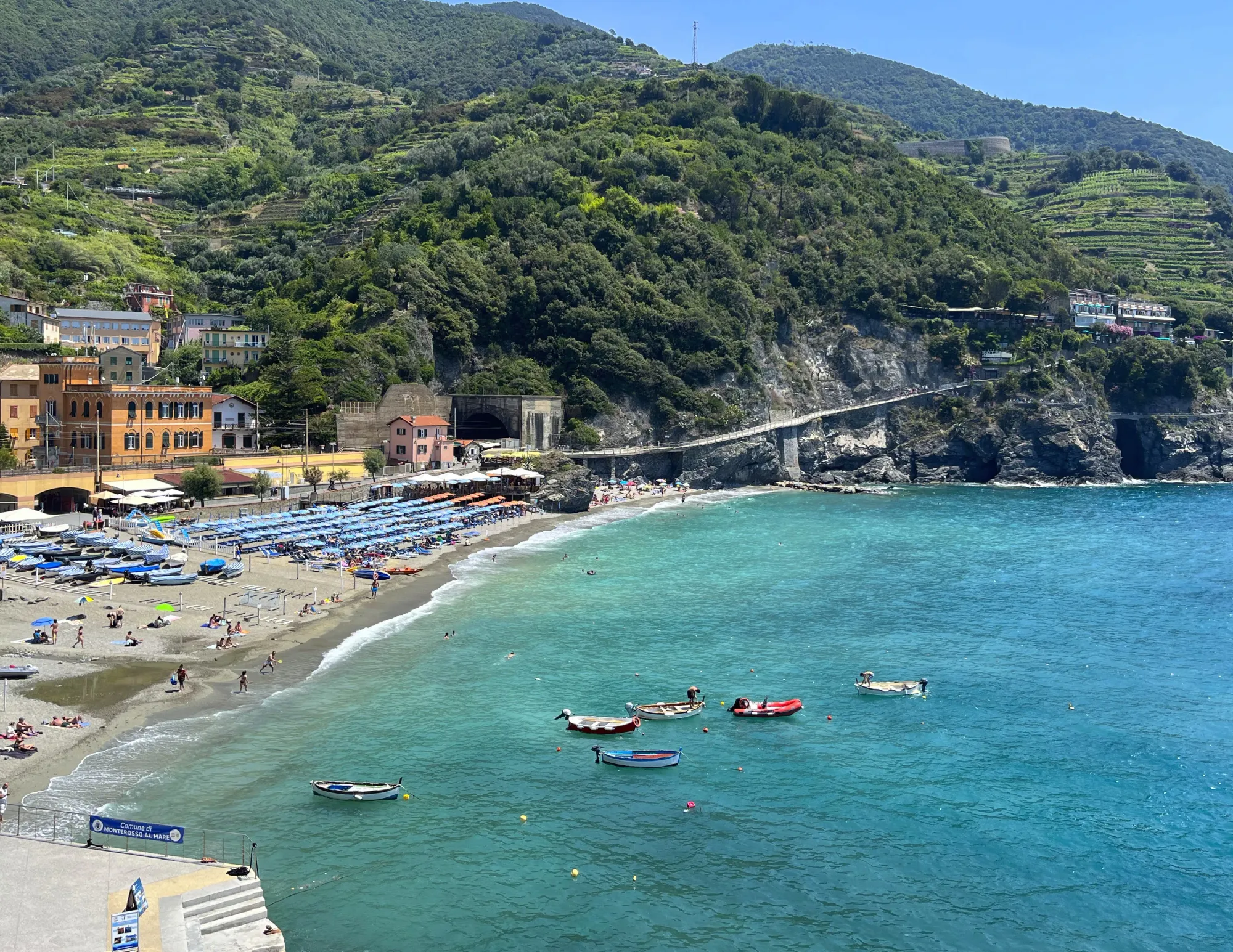 View overlooking the water and boats surrounded by terraced mountains