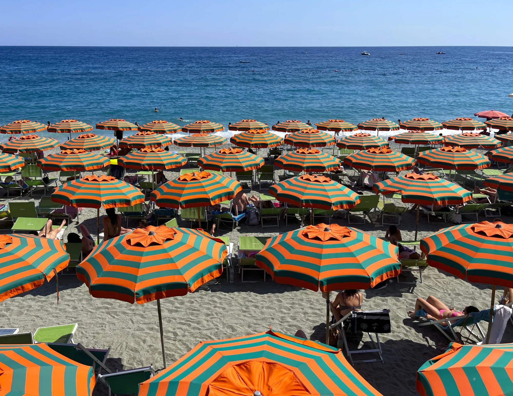 Orange and Green striped umbrellas on the beach