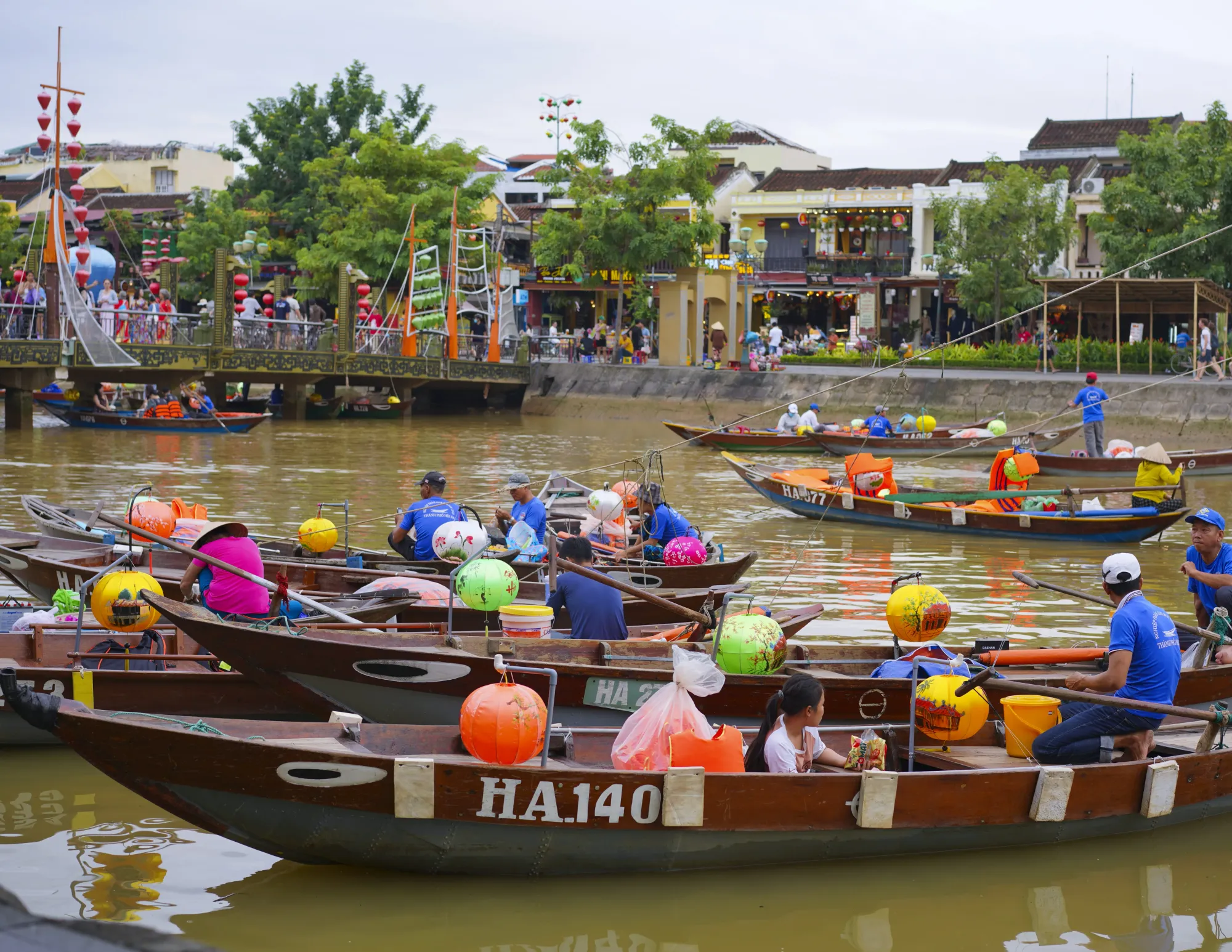 Long boats decorated with round colorful paper lanterns