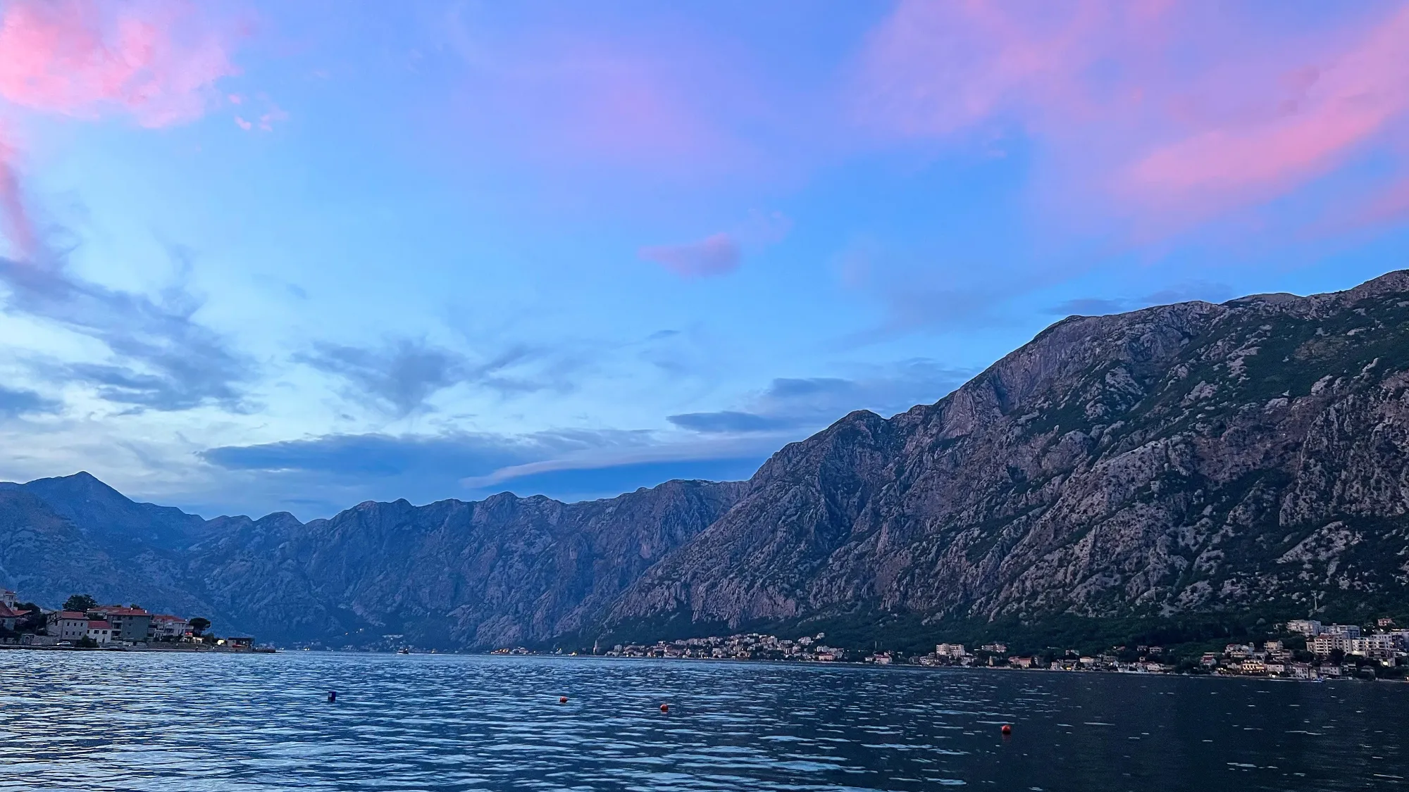 Kotor Bay in the evening with blue skies and pink clouds