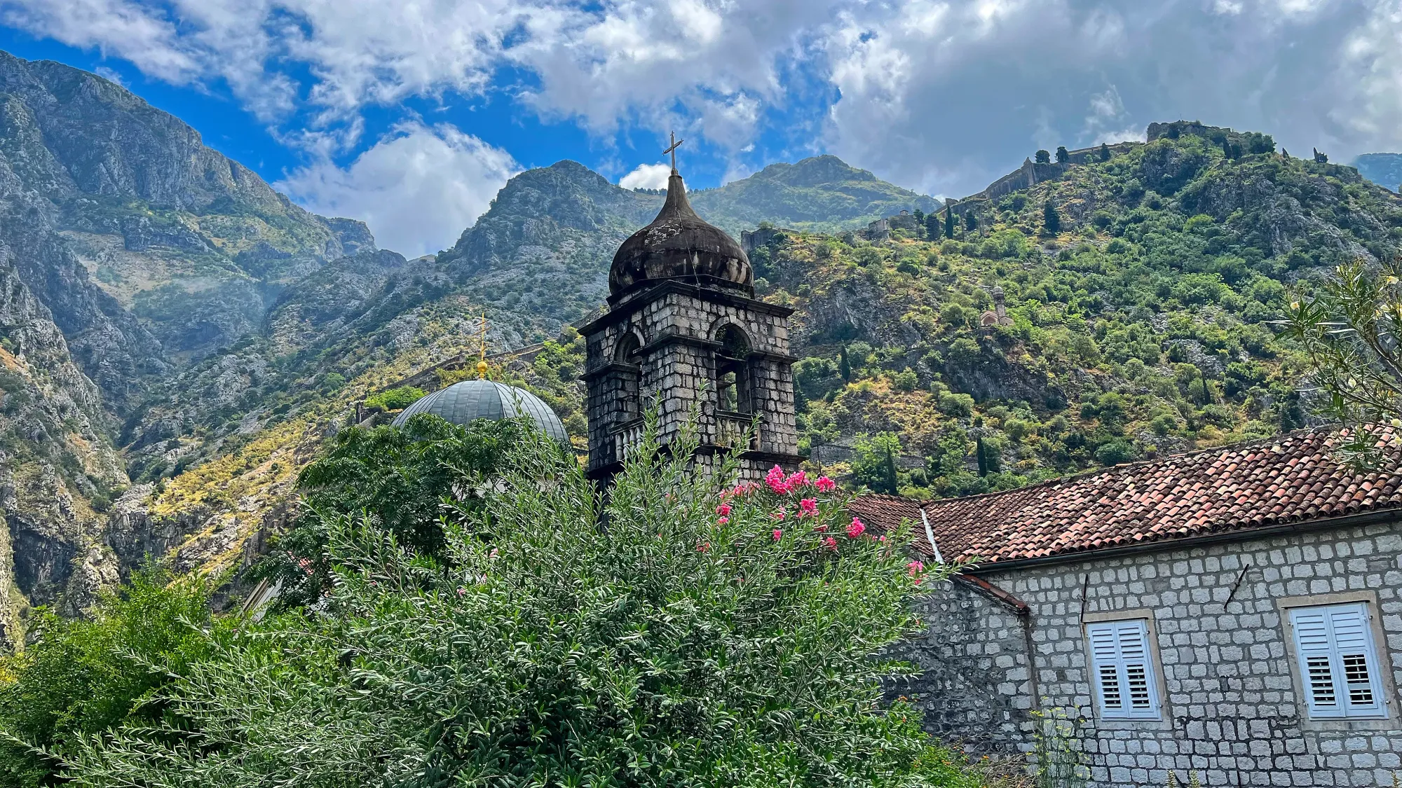 Stone buildings with the moutains set behind them