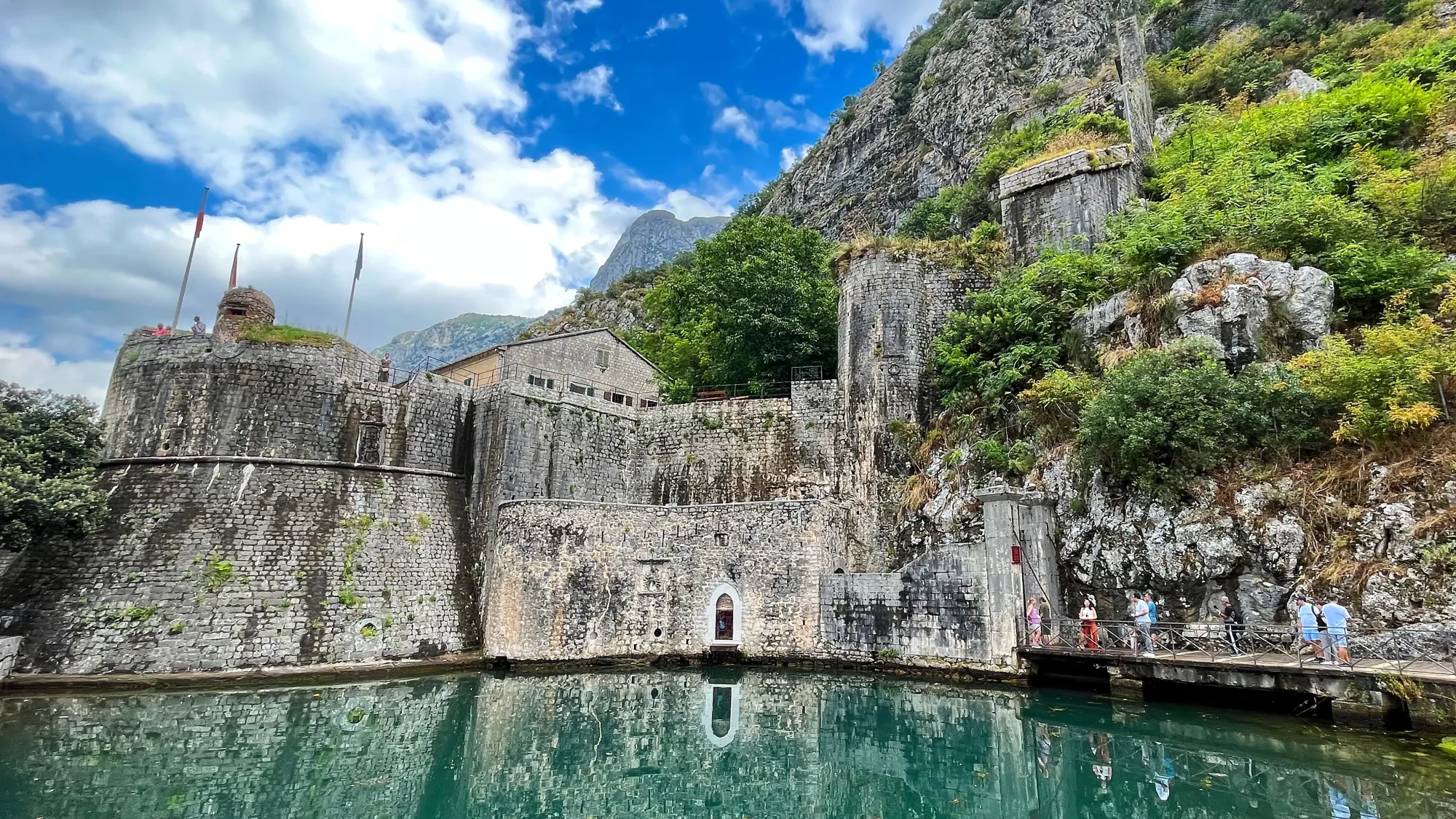 Grey stone gate with reflective moat