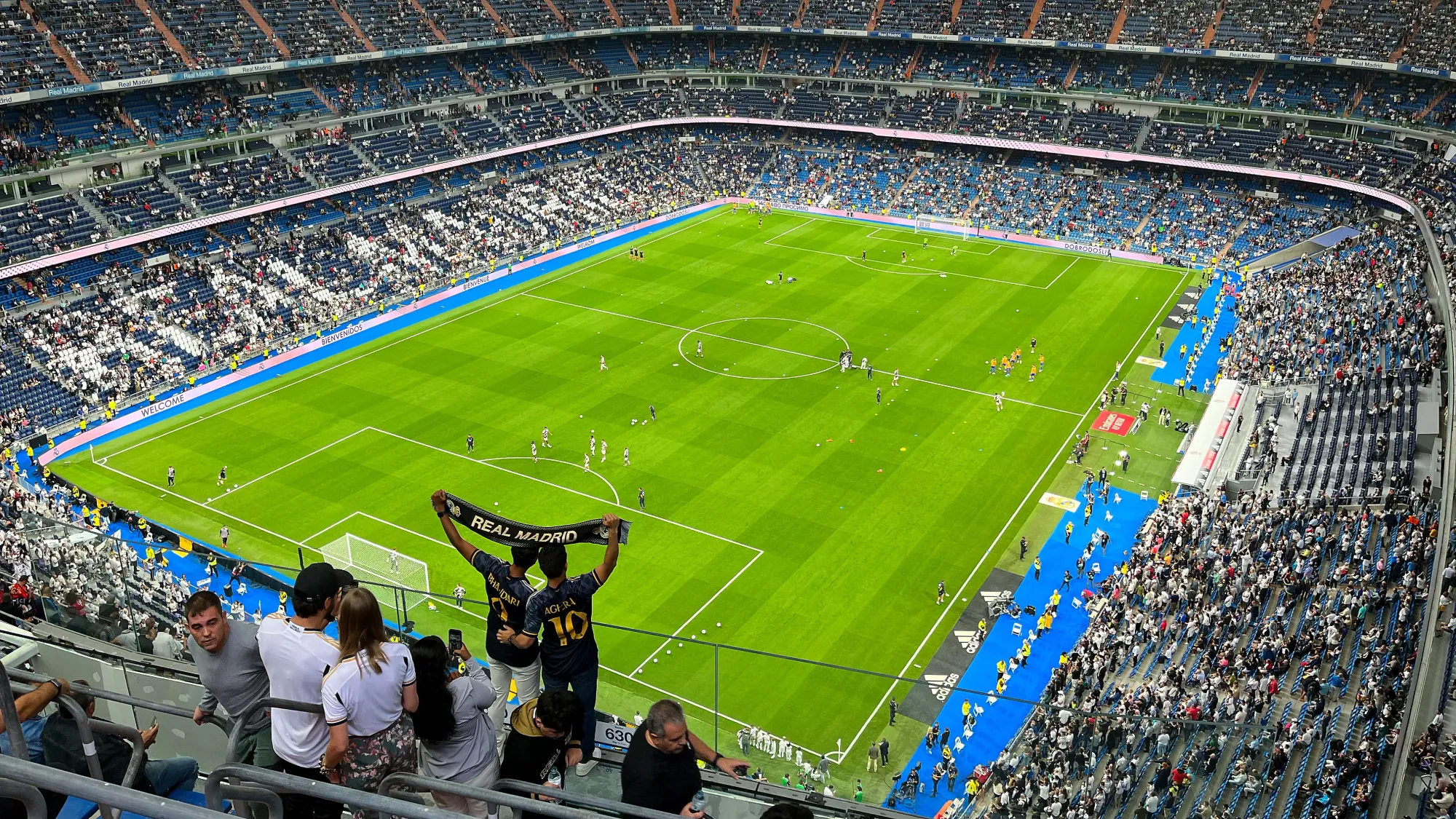 Soccer stadium with fans holding up a soccer scarf