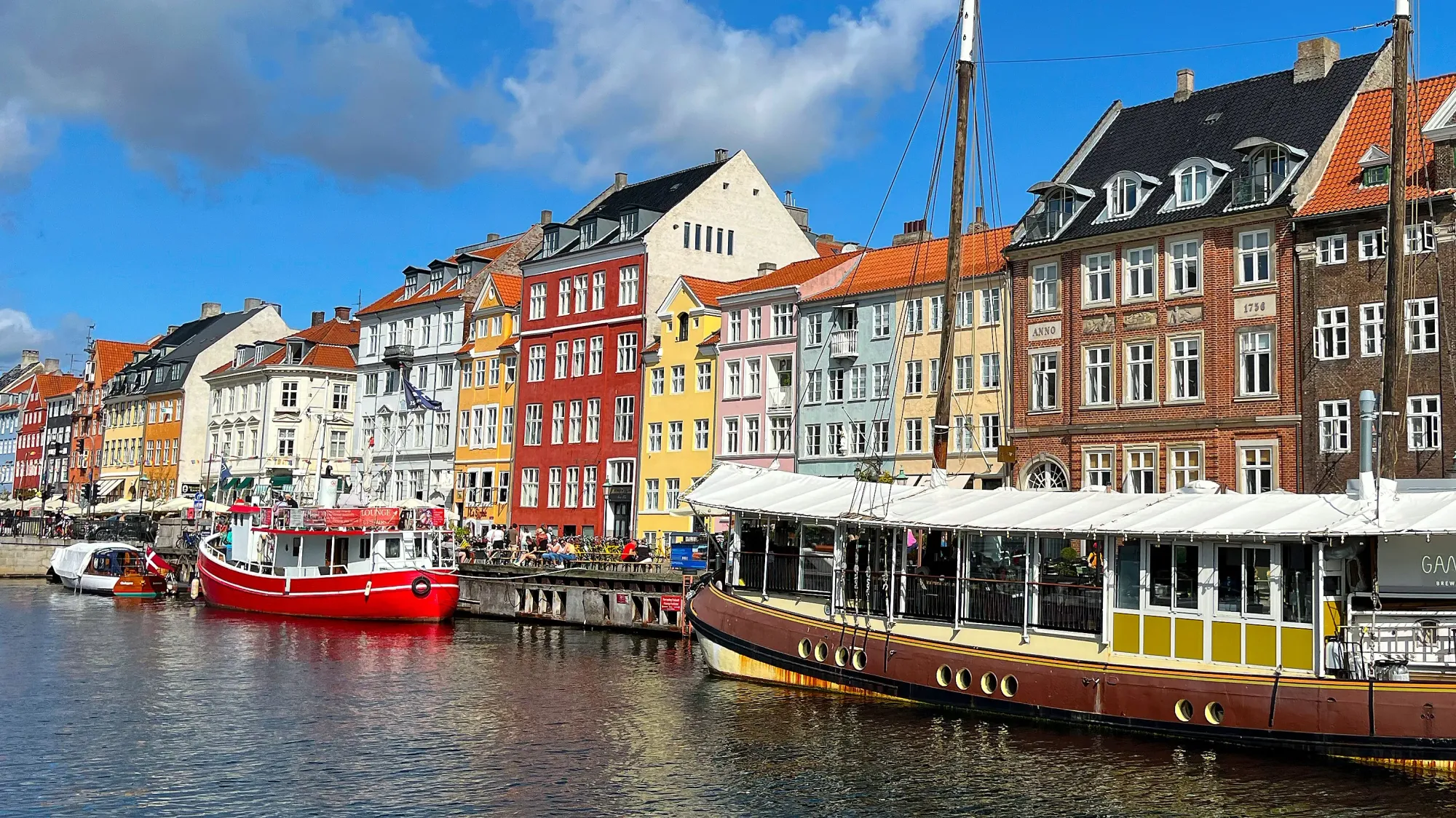 Canal with boats and colored buildings lining it