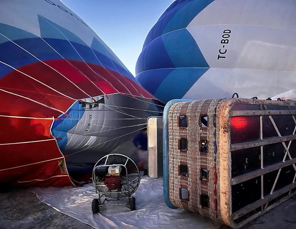 Hot air balloon mid-inflation with an overturned basket