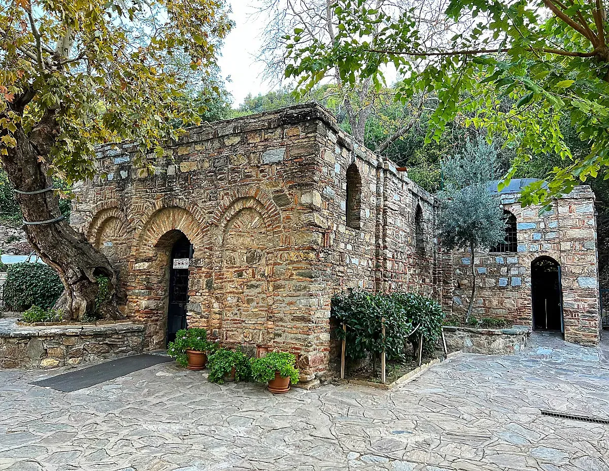 Small stone structure surrounded by trees