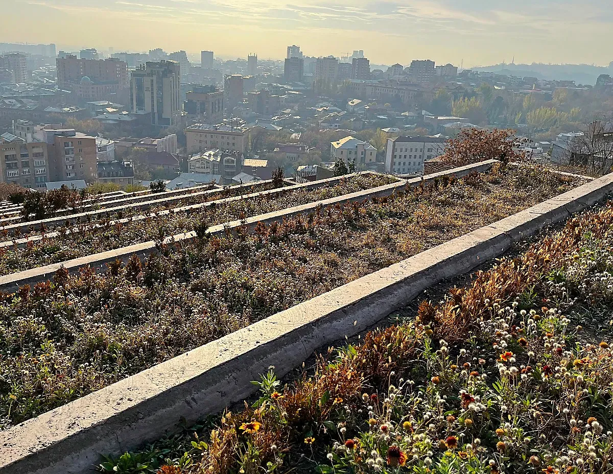 Flower beds along the cascading marble steps overlooking the skyline of Yerevan