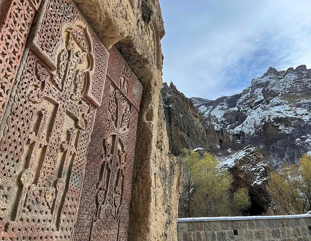 Ornate crossed carved into the side of a stone building