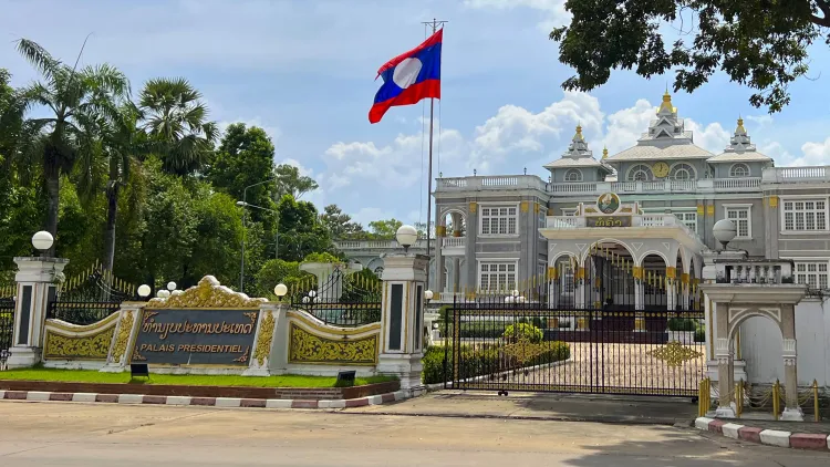 Front shot of the Laotian Presidential Palace with flying flag